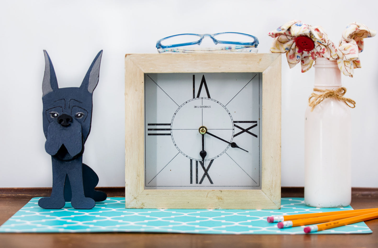 A handcrafted wooden Great Dane eyeglasses holder designed to resemble the iconic breed, available with floppy or docked ears. Comes in black, blue, fawn, or detailed mantle coloring. Floppy ear version measures 6.35" tall by 4.35" wide; docked ear version stands 8.5" tall by 3.15" wide. Perfect for organizing glasses on desks or nightstands, and makes a great gift for Great Dane lovers.