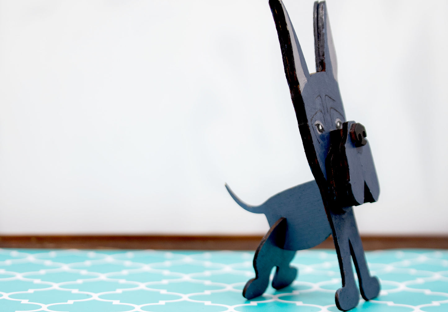 A handcrafted wooden Great Dane eyeglasses holder designed to resemble the iconic breed, available with floppy or docked ears. Comes in black, blue, fawn, or detailed mantle coloring. Floppy ear version measures 6.35" tall by 4.35" wide; docked ear version stands 8.5" tall by 3.15" wide. Perfect for organizing glasses on desks or nightstands, and makes a great gift for Great Dane lovers.
