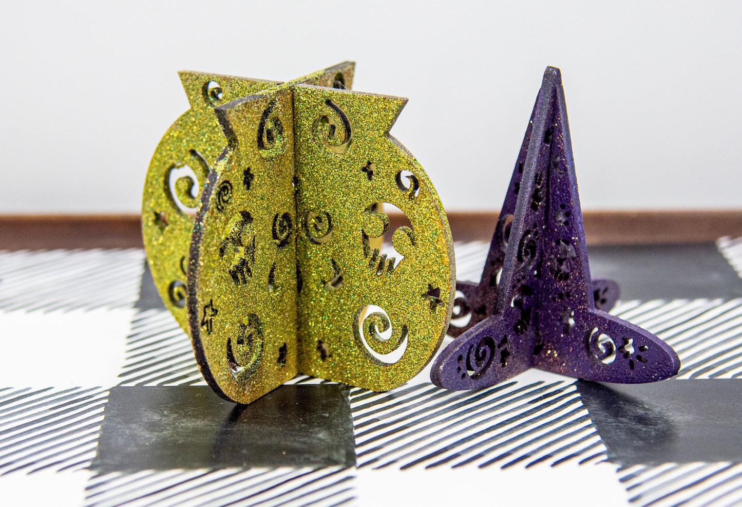 Colorful 3D Halloween shelf sitters made of sliding interlocking wooden pieces, including a pumpkin, haunted house, cat, witch hat, cauldron, and tree. Painted in spooky fall tones from 3 to 7 inches tall.