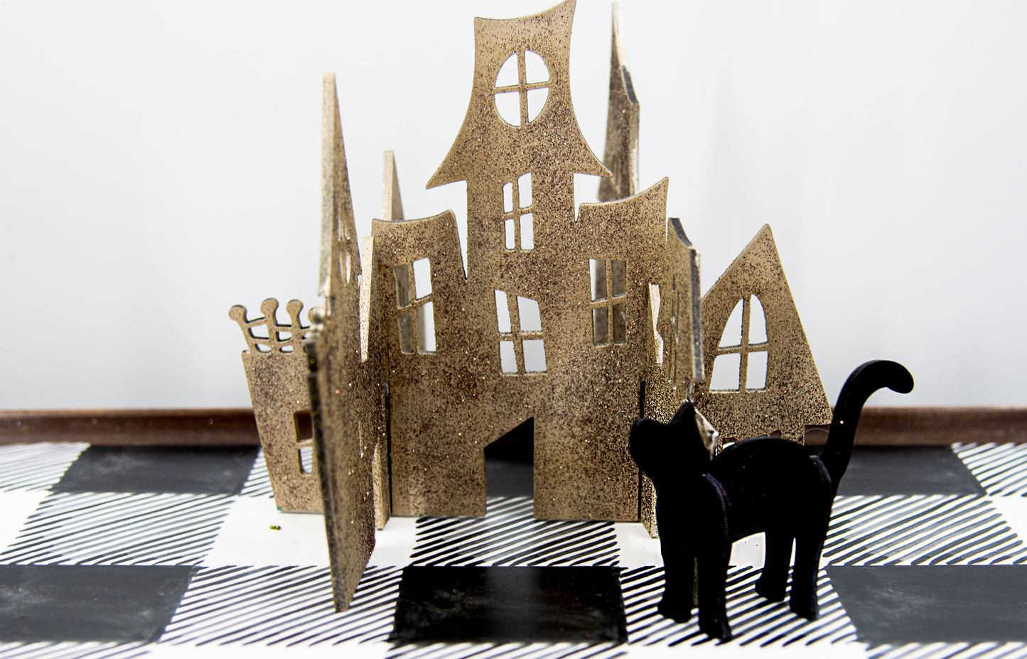 Colorful 3D Halloween shelf sitters made of sliding interlocking wooden pieces, including a pumpkin, haunted house, cat, witch hat, cauldron, and tree. Painted in spooky fall tones from 3 to 7 inches tall.