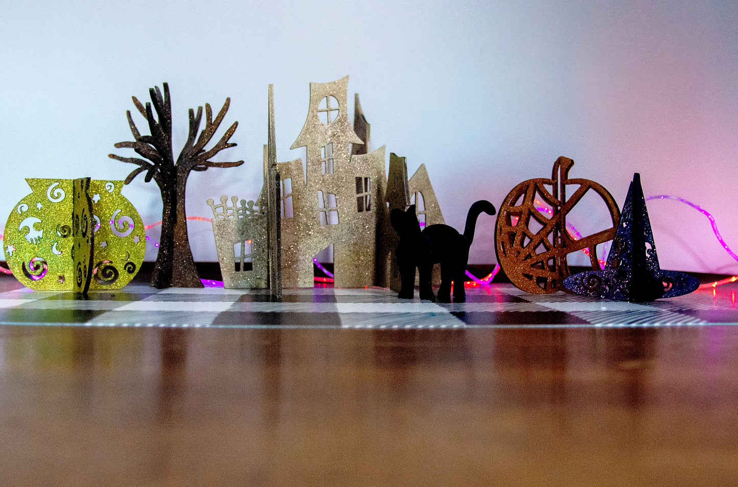 Colorful 3D Halloween shelf sitters made of sliding interlocking wooden pieces, including a pumpkin, haunted house, cat, witch hat, cauldron, and tree. Painted in spooky fall tones from 3 to 7 inches tall.