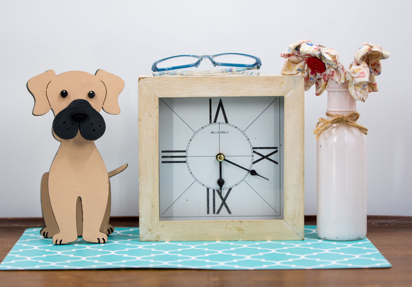 Handmade wooden glasses holder shaped like a Mastiff dog, featuring carved facial details and a sturdy snout that securely holds eyeglasses. Finished in rustic tones with optional personalization, this stand is perfect for Mastiff lovers and adds charm and function to any desk, nightstand, or shelf.
