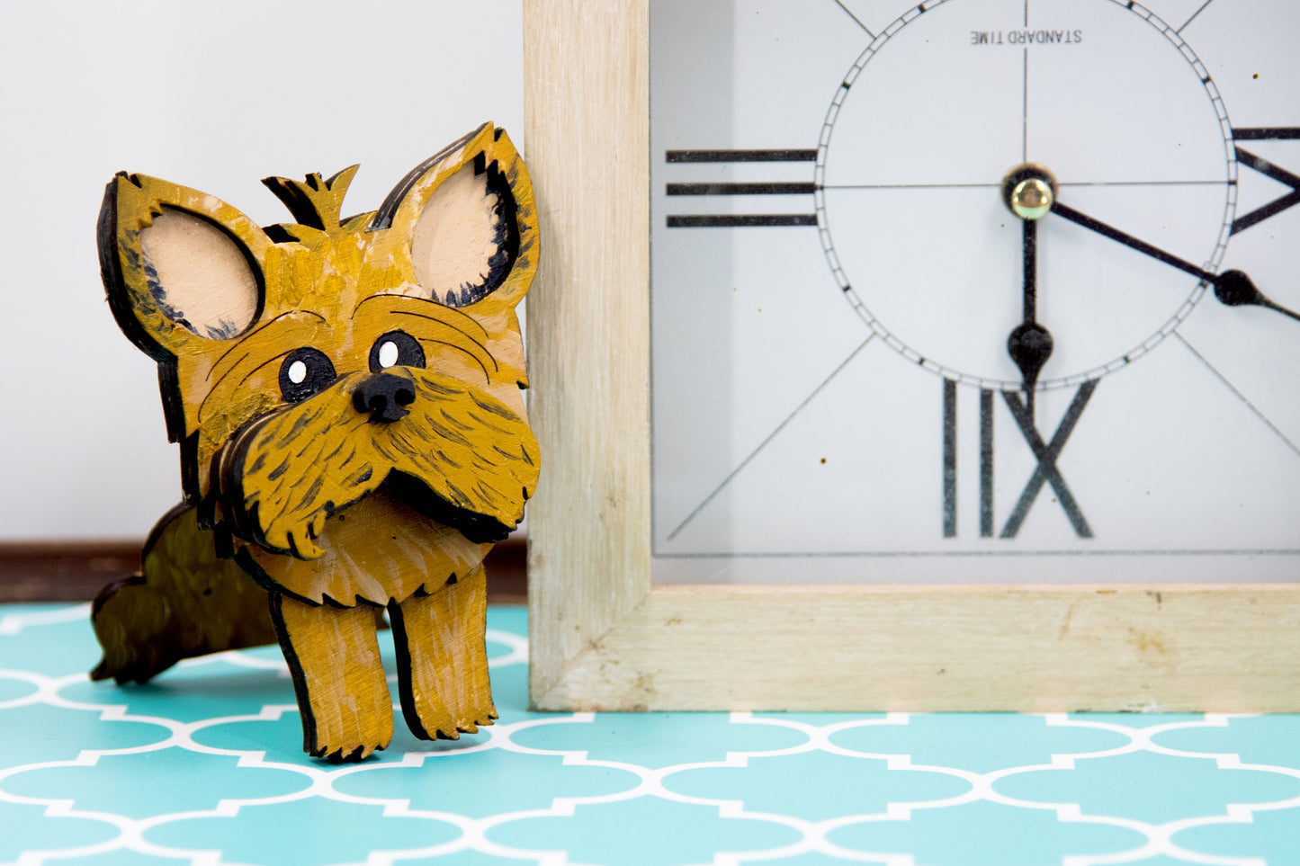 Hand-painted wooden glasses holder shaped like a Yorkshire Terrier with signature silky fur and upright ears, designed to hold eyeglasses on its face. Perfect for Yorkie lovers