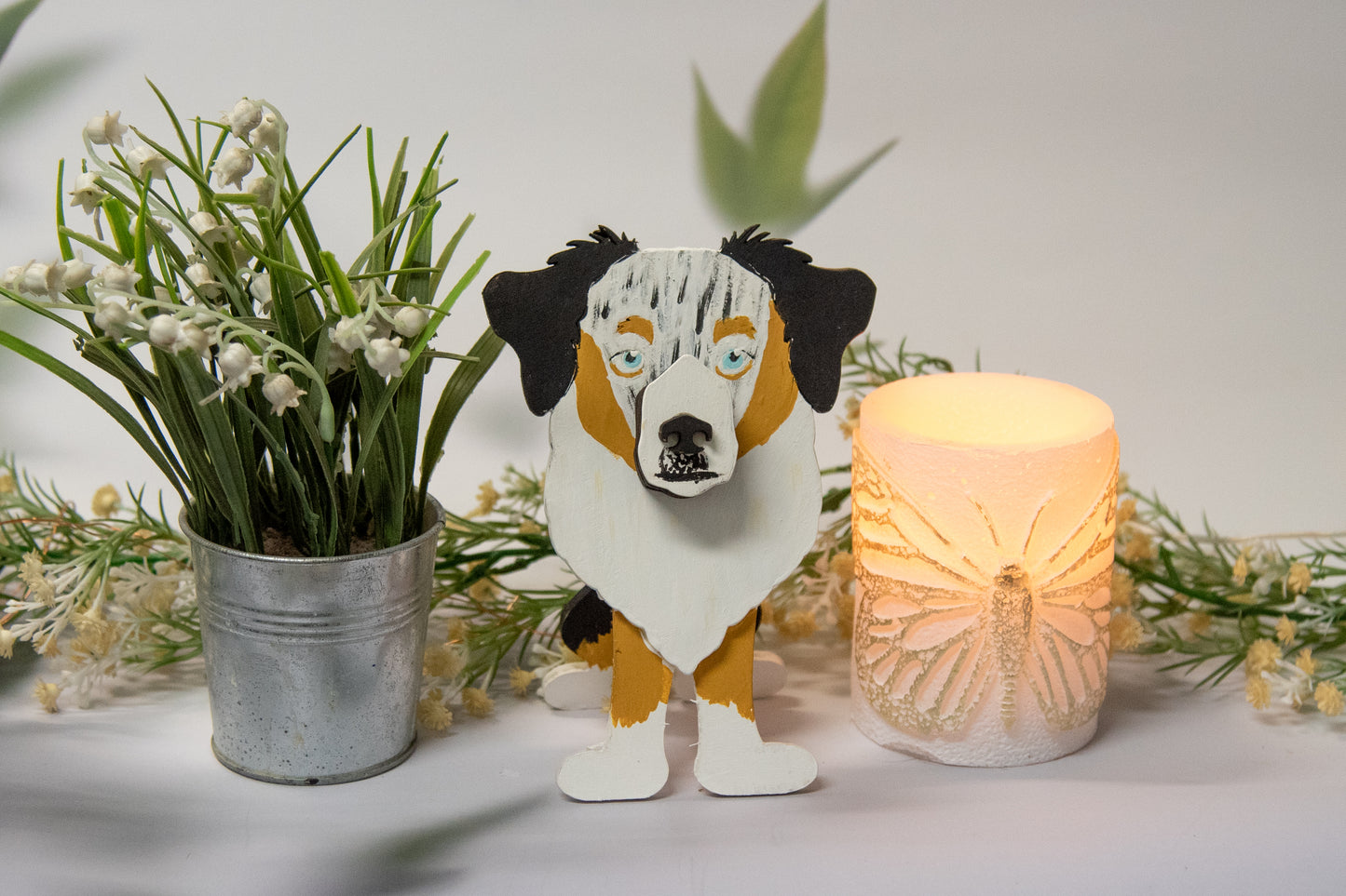 Hand-painted Australian Shepherd eyeglass holder in a sitting dog shape, available in Blue Merle, Red Merle, Black Tri, or custom colors with realistic details, designed to hold glasses on the snout. Cute and functional dog lover gift, hand-crafted and great for desks or nightstands.
