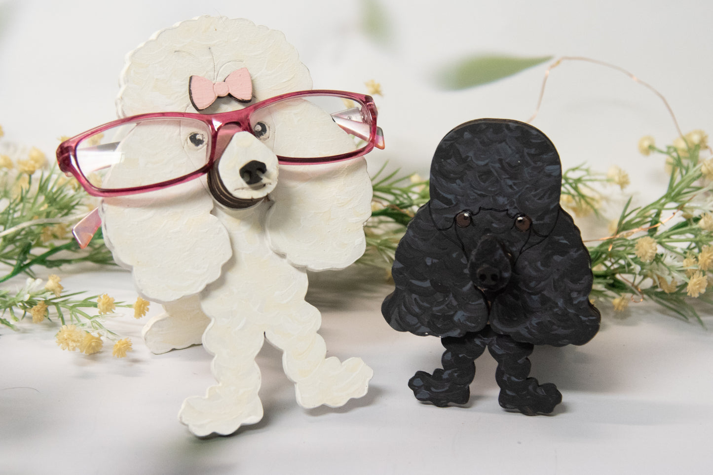 Handcrafted wooden poodle glasses holder stand in standard or miniature poodle shape, with optional bow detail, shown in black and white but fully customizable, unique dog lover gift