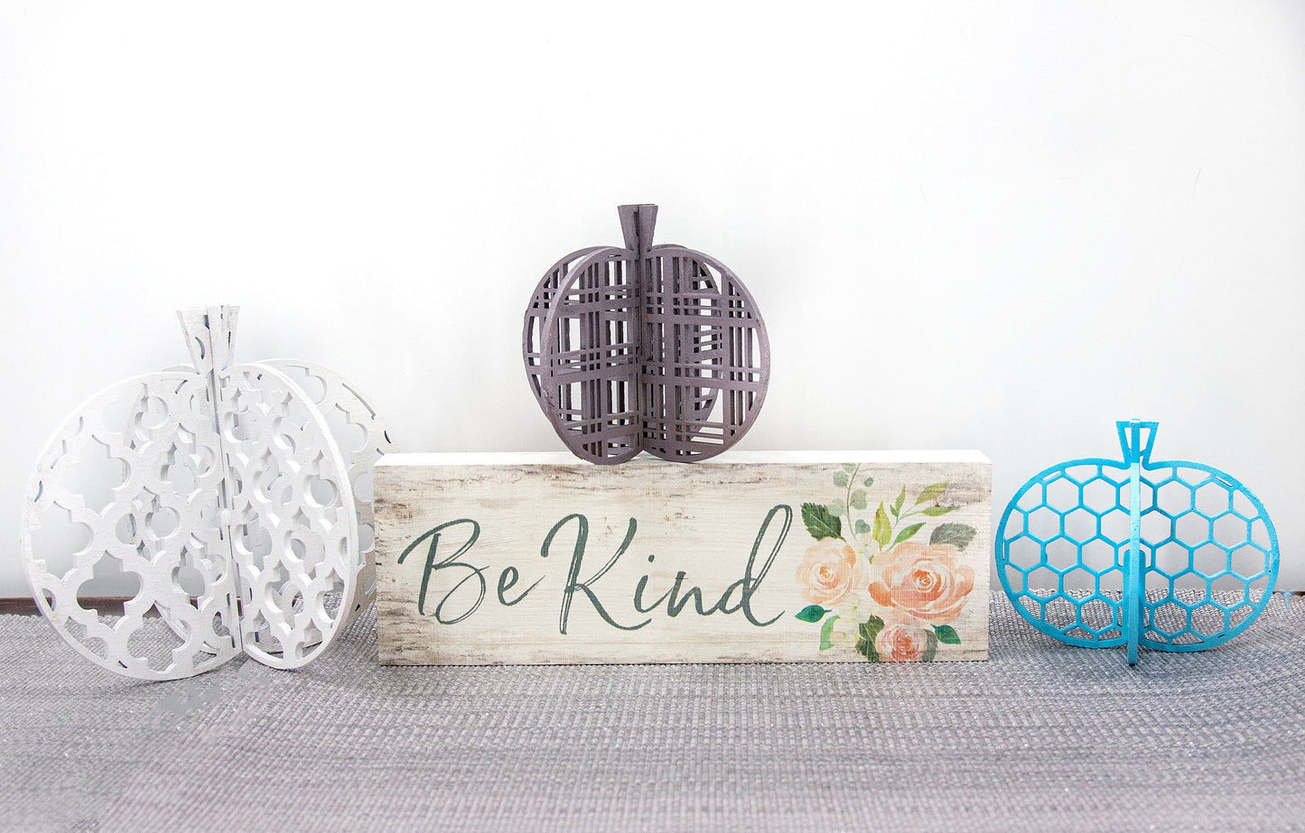 Set of handcrafted 3D wooden pumpkins in fall colors with interlocking design, standing upright for tiered trays or shelf decor, available in custom or traditional autumn tones.