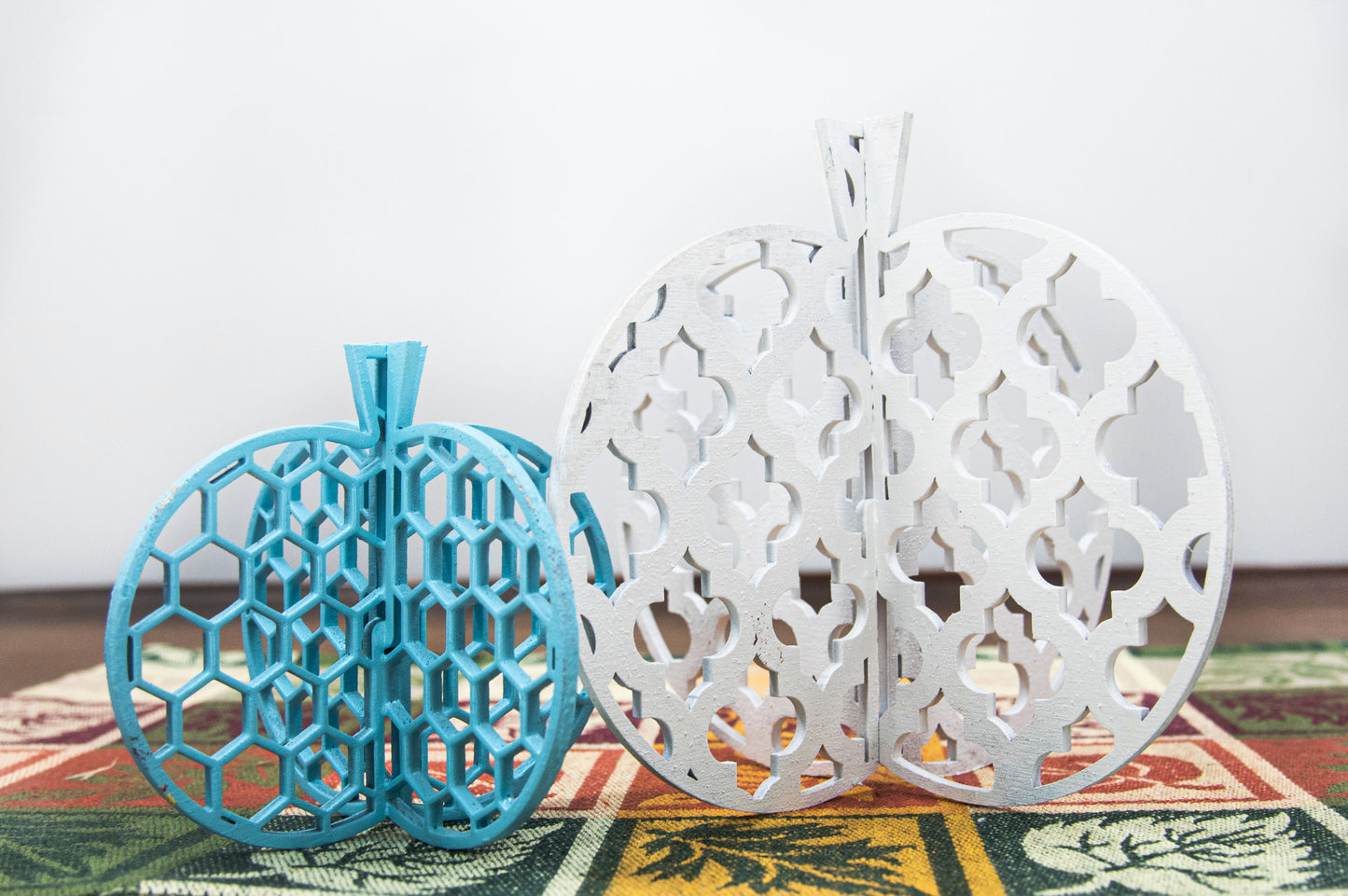 A handcrafted set of 3D wooden pumpkins designed to slot together and stand upright, perfect for Halloween or fall home decor. Each pumpkin features layered wood details and a freestanding base. Great for shelf styling, entry tables, tiered trays, or Thanksgiving centerpieces.
