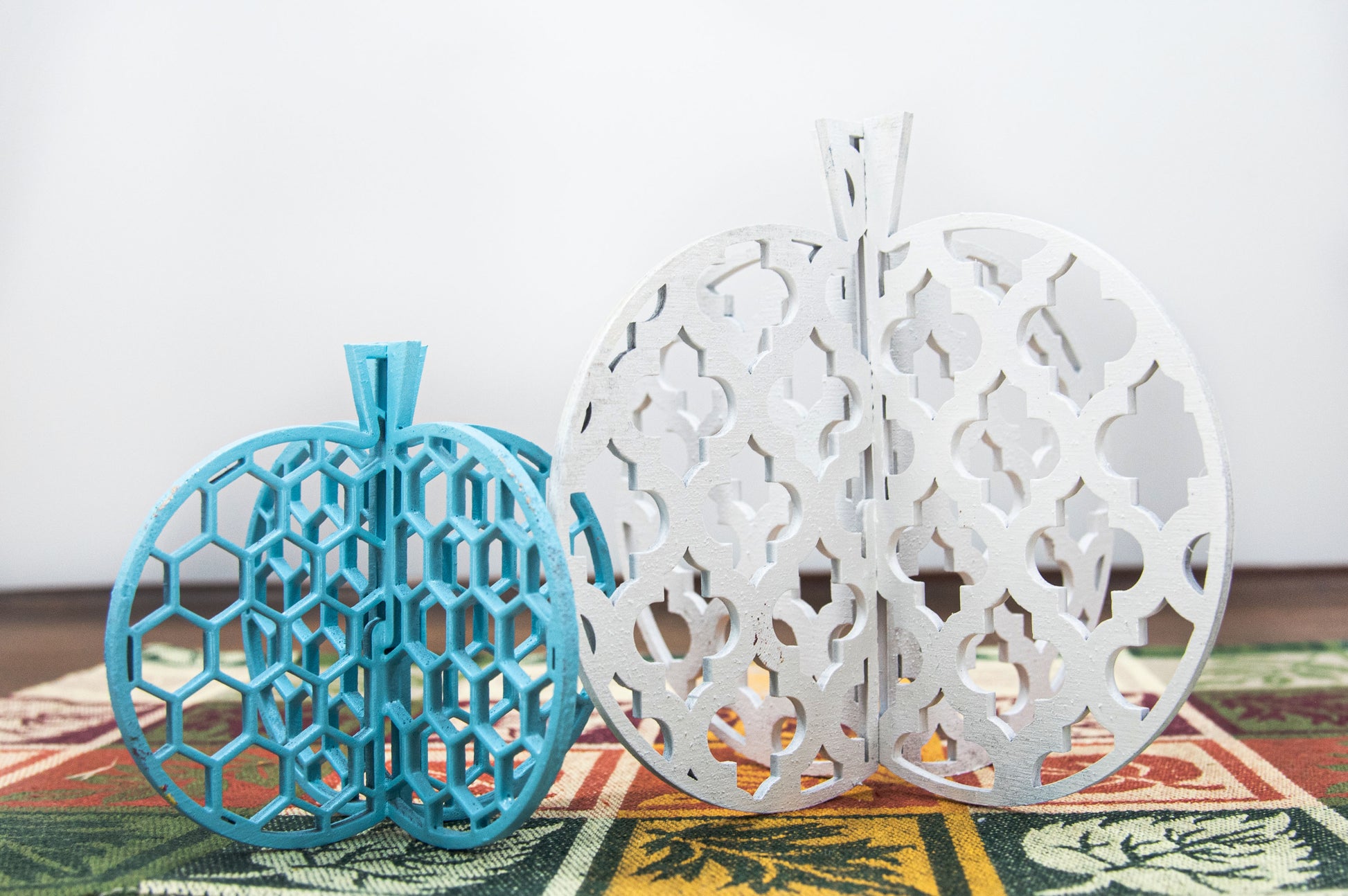 A handcrafted set of 3D wooden pumpkins designed to slot together and stand upright, perfect for Halloween or fall home decor. Each pumpkin features layered wood details and a freestanding base. Great for shelf styling, entry tables, tiered trays, or Thanksgiving centerpieces.
