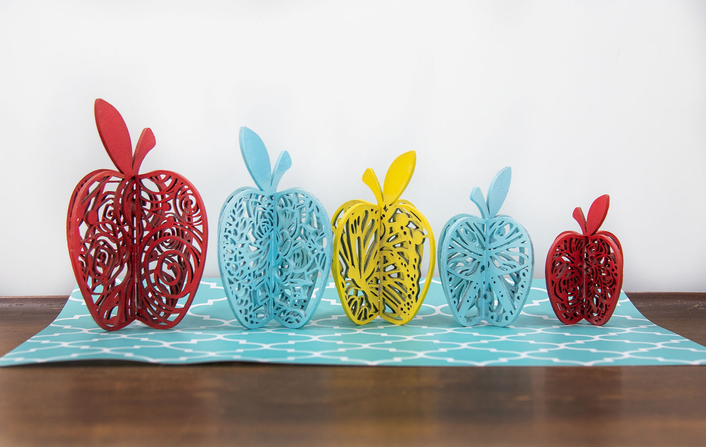 Handcrafted wooden apple shelf sitters, each uniquely painted in rustic fall colors and whimsical patterns. These small decorative apples measure between 3.25 to 5 inches and are perfect for adding seasonal charm to farmhouse shelves, tiered trays, mantels, or classroom decor. A cozy handmade gift idea for teachers, autumn decorating, or adding a pop of color to your rustic home aesthetic