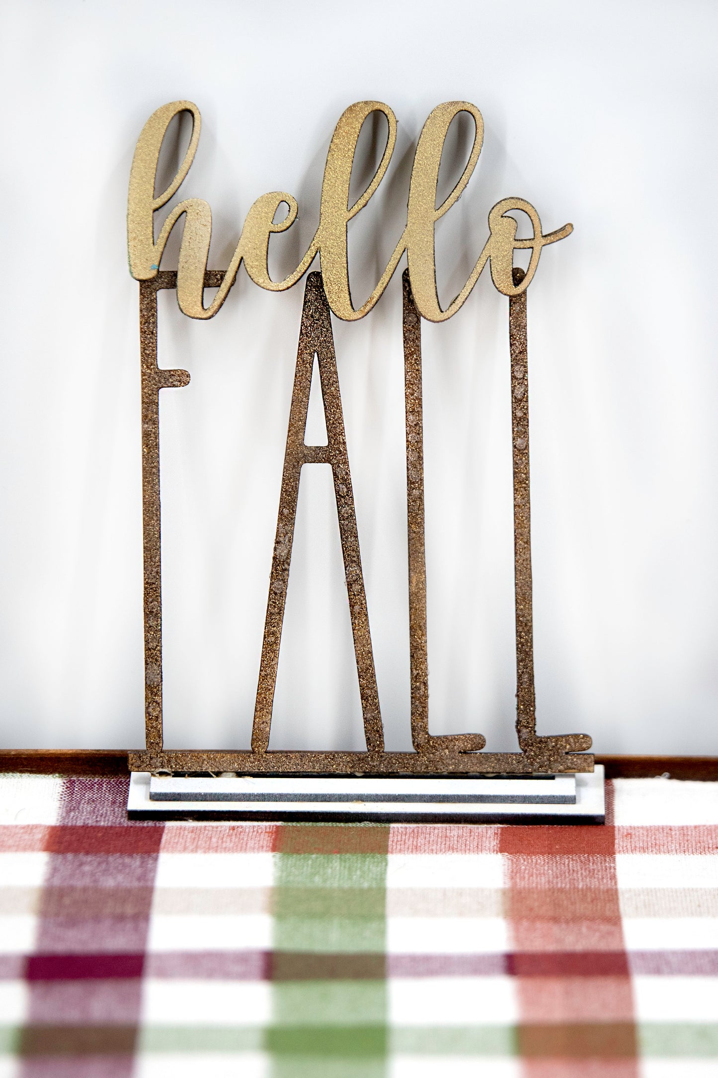 Layered standing wooden pumpkins ranging from 5.5 to 8 inches tall, featuring a solid color background and patterned top layer in assorted fall colors and rustic prints. Some designs include engraved words like 'Blessed' and 'Grateful.' Each pumpkin stands on a wooden base, making them ideal for fall shelf decor, Thanksgiving displays, or farmhouse-style seasonal arrangements.