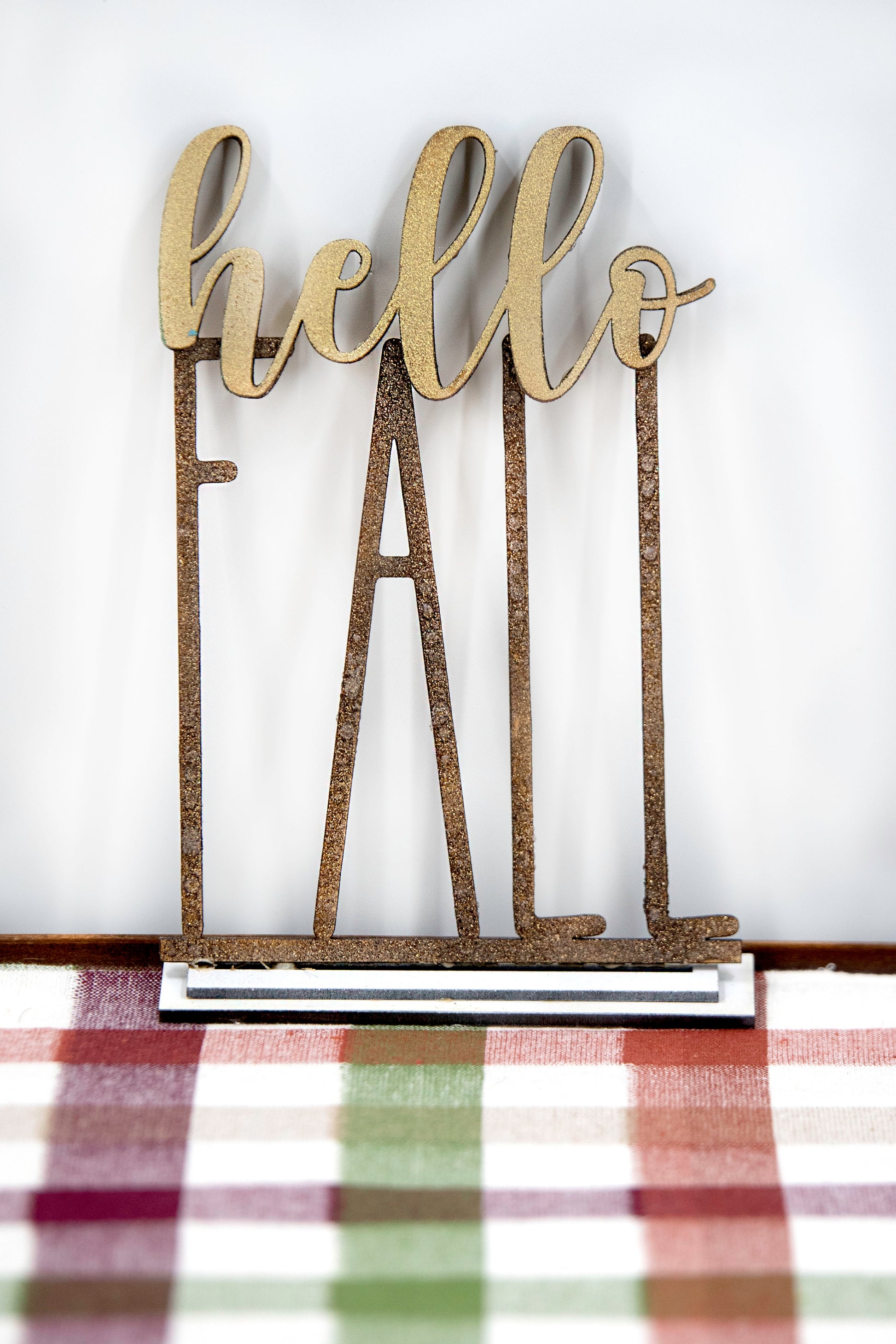 Layered standing wooden pumpkins ranging from 5.5 to 8 inches tall, featuring a solid color background and patterned top layer in assorted fall colors and rustic prints. Some designs include engraved words like 'Blessed' and 'Grateful.' Each pumpkin stands on a wooden base, making them ideal for fall shelf decor, Thanksgiving displays, or farmhouse-style seasonal arrangements.