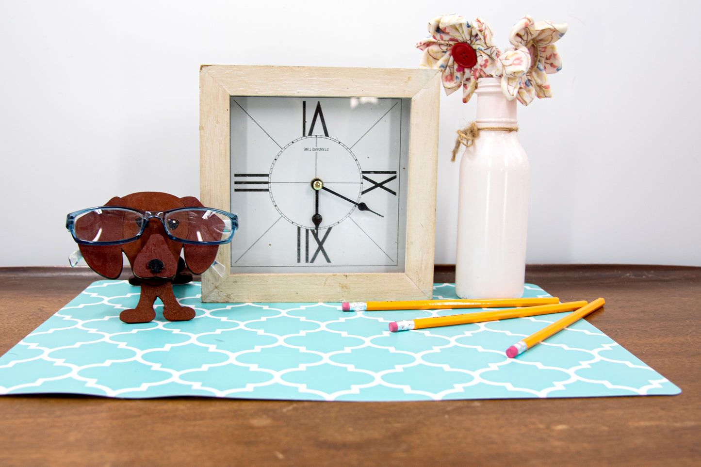 Handcrafted small wooden glasses holder in the shape of a Dachshund, featuring a painted dog design with carved detail and a curved snout to hold eyeglasses securely. A compact and charming gift for dog lovers, especially fans of wiener dogs, and perfect for display on a nightstand, office desk, or bookshelf.