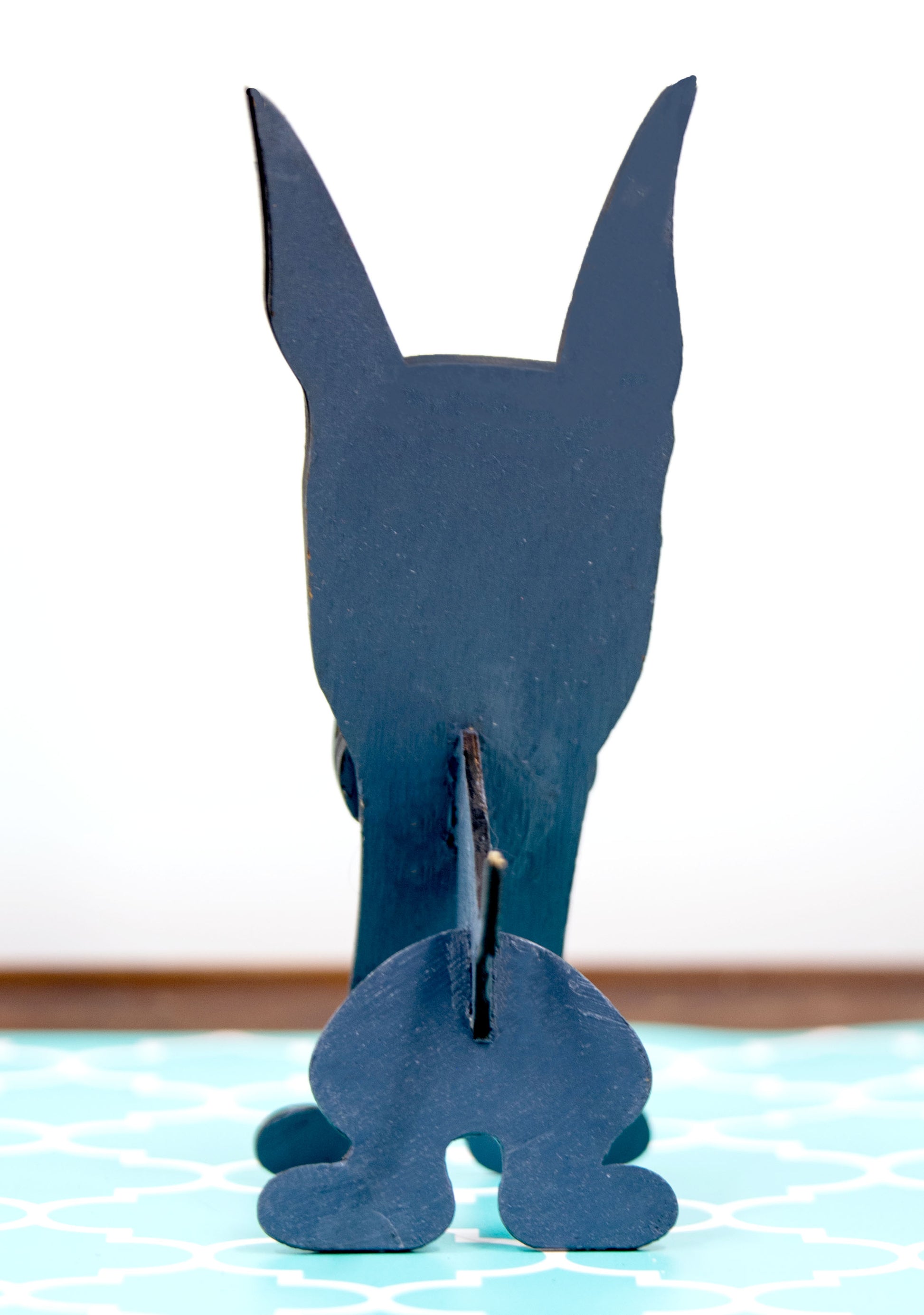 A handcrafted wooden Great Dane eyeglasses holder designed to resemble the iconic breed, available with floppy or docked ears. Comes in black, blue, fawn, or detailed mantle coloring. Floppy ear version measures 6.35" tall by 4.35" wide; docked ear version stands 8.5" tall by 3.15" wide. Perfect for organizing glasses on desks or nightstands, and makes a great gift for Great Dane lovers.