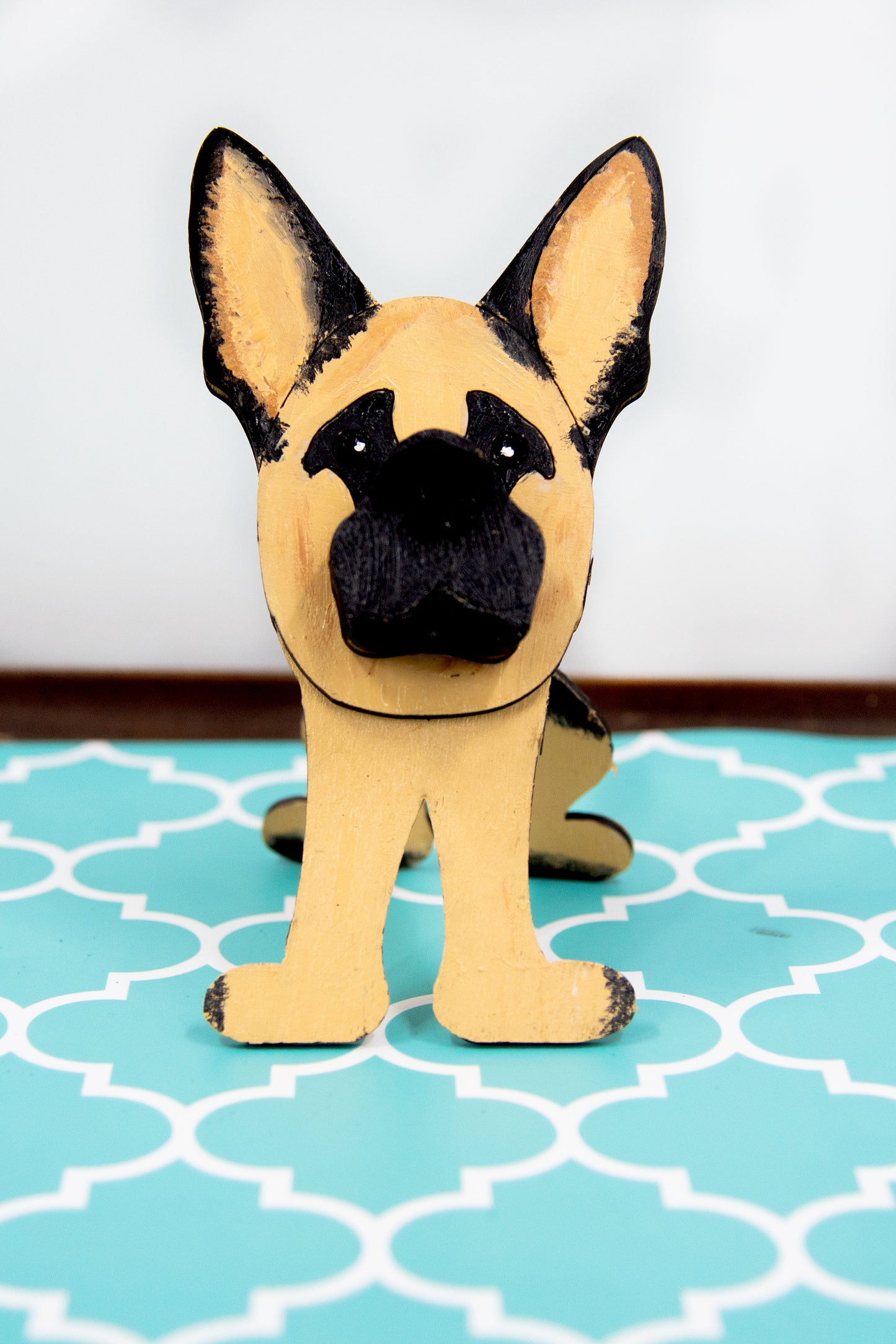Handmade wooden German Shepherd glasses holder, crafted with carved facial details and a secure snout-shaped rest for eyeglasses. Finished in rustic paint tones with optional personalization, this dog-shaped stand is both a charming gift and a functional decor piece for pet lovers, especially German Shepherd owners. Ideal for desks, nightstands, or entry tables.