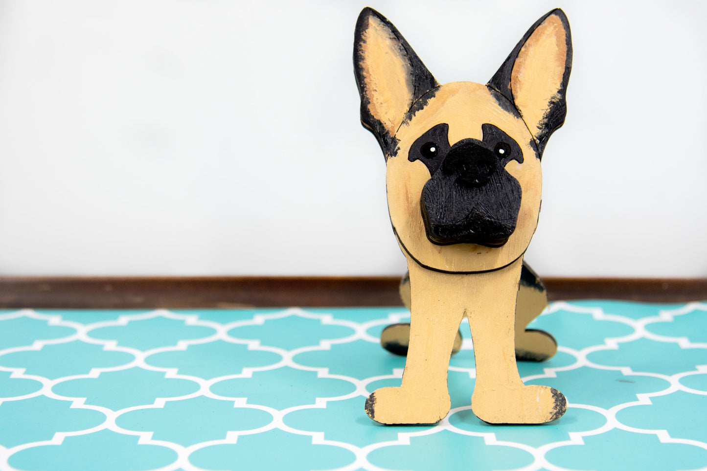 Handmade wooden German Shepherd glasses holder, crafted with carved facial details and a secure snout-shaped rest for eyeglasses. Finished in rustic paint tones with optional personalization, this dog-shaped stand is both a charming gift and a functional decor piece for pet lovers, especially German Shepherd owners. Ideal for desks, nightstands, or entry tables.