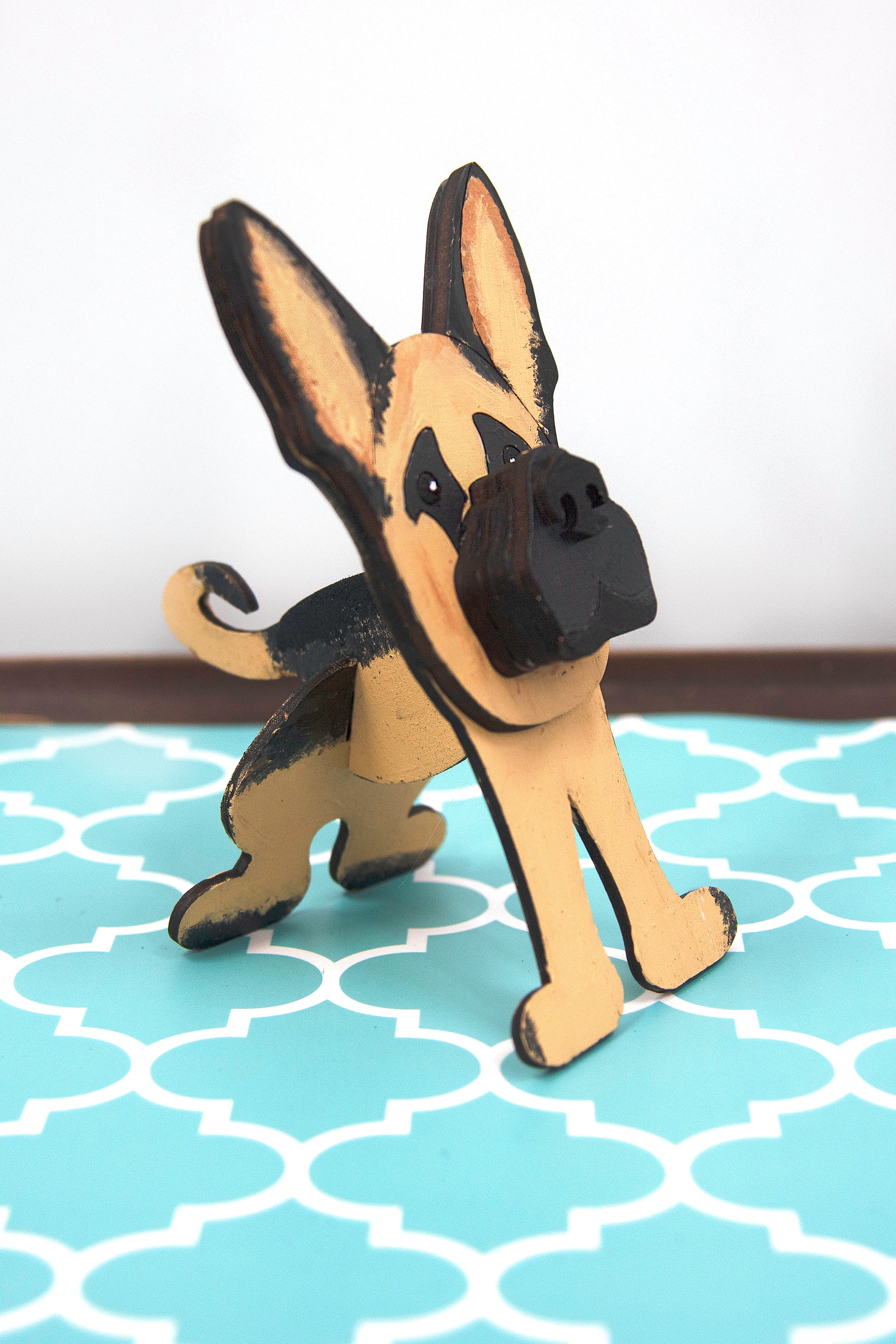 Handmade wooden German Shepherd glasses holder, crafted with carved facial details and a secure snout-shaped rest for eyeglasses. Finished in rustic paint tones with optional personalization, this dog-shaped stand is both a charming gift and a functional decor piece for pet lovers, especially German Shepherd owners. Ideal for desks, nightstands, or entry tables.