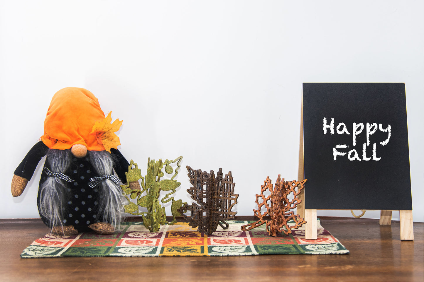 Freestanding 3D wooden leaf shelf sitters crafted with an interlocking two-piece design, painted in warm autumn colors such as orange, red, yellow, and brown. Each leaf features intricate engraved patterns and textures, making them perfect for seasonal tiered trays, mantels, or fall-themed centerpieces. Sizes range from 3 to 5.5 inches tall, with customizable color options for a unique, rustic autumn decor touch.
