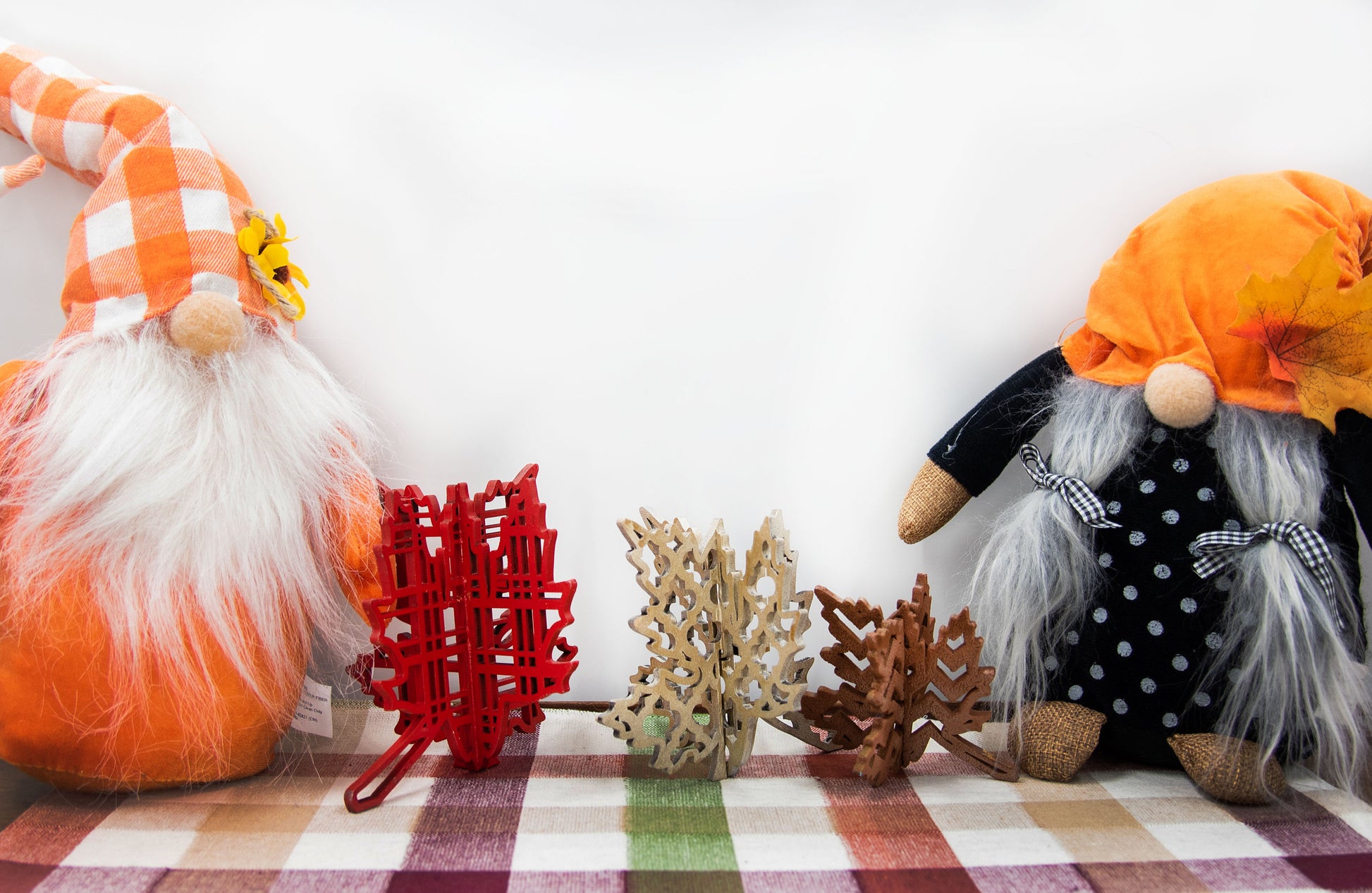 Freestanding 3D wooden leaf shelf sitters crafted with an interlocking two-piece design, painted in warm autumn colors such as orange, red, yellow, and brown. Each leaf features intricate engraved patterns and textures, making them perfect for seasonal tiered trays, mantels, or fall-themed centerpieces. Sizes range from 3 to 5.5 inches tall, with customizable color options for a unique, rustic autumn decor touch.
