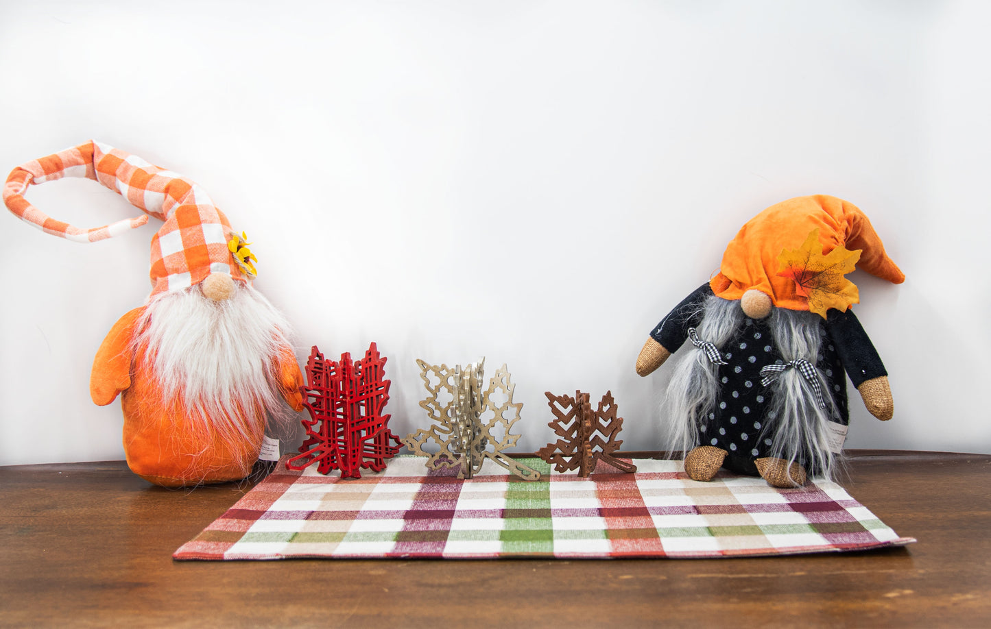 Freestanding 3D wooden leaf shelf sitters crafted with an interlocking two-piece design, painted in warm autumn colors such as orange, red, yellow, and brown. Each leaf features intricate engraved patterns and textures, making them perfect for seasonal tiered trays, mantels, or fall-themed centerpieces. Sizes range from 3 to 5.5 inches tall, with customizable color options for a unique, rustic autumn decor touch.

