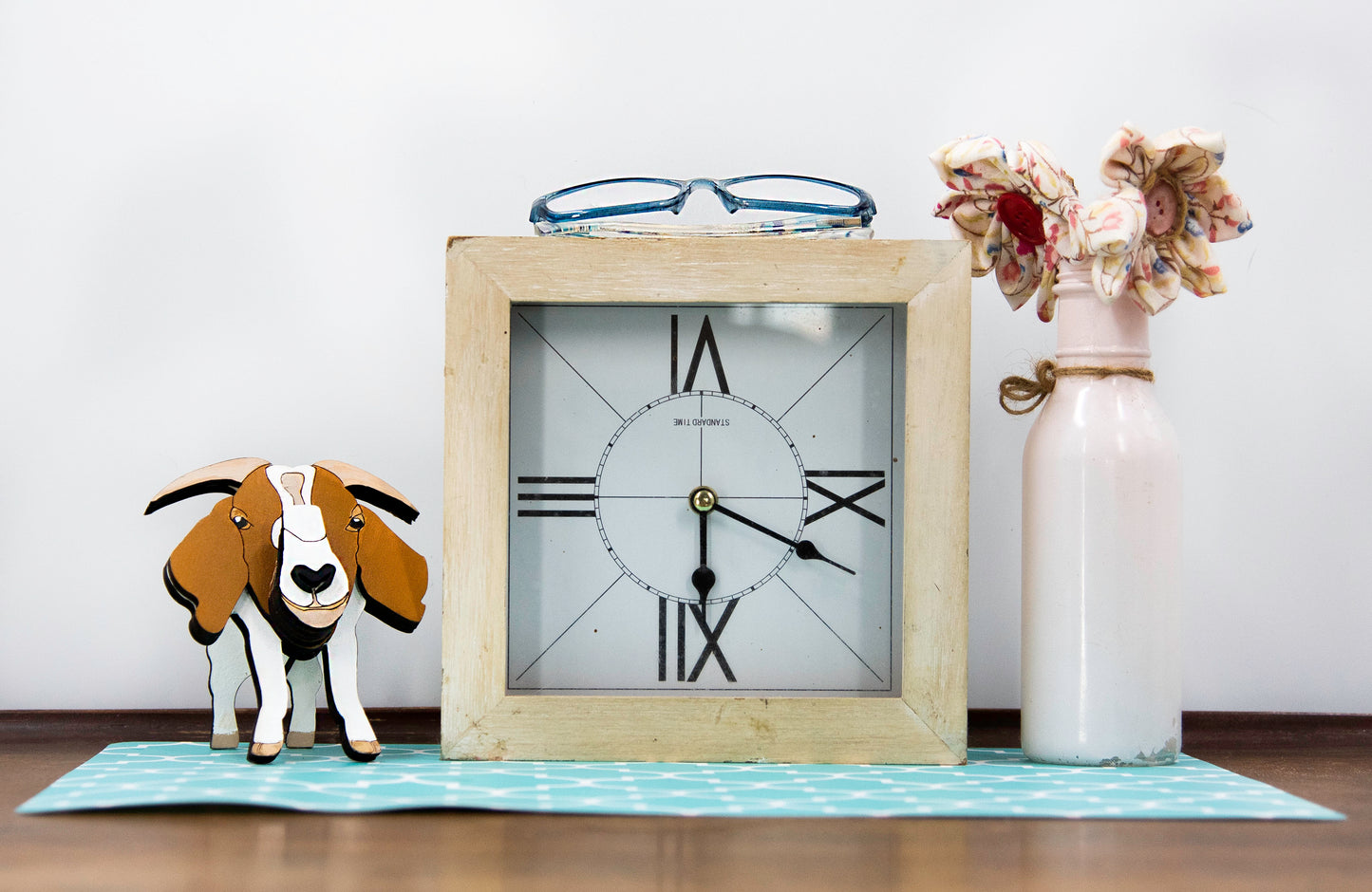 Handcrafted wooden goat glasses holder featuring carved facial details, horns, and a sturdy snout to support eyeglasses. Painted in rustic tones, this charming eyeglass stand is perfect for goat enthusiasts, farmers, or anyone who loves quirky animal decor.
