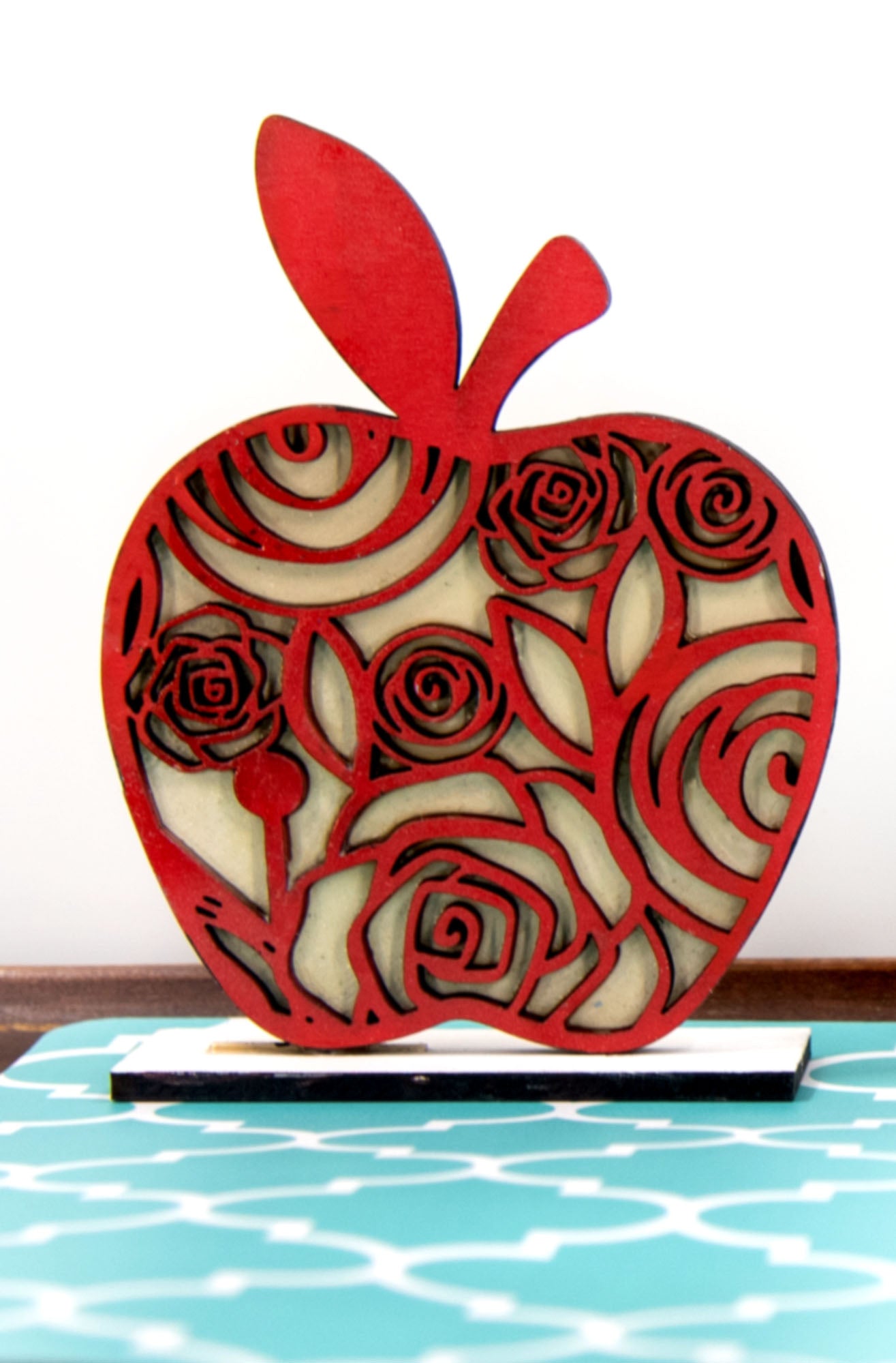 A handcrafted set of three standing wooden apple shelf sitters in assorted fall colors and patterns. These tiered tray-ready decorations include a rustic base and patterned top layer. Available individually or as a complete set, they bring warmth and charm to autumn home decor, classroom displays, or teacher gifts. Sizes range from 3.75" to 5.5".
