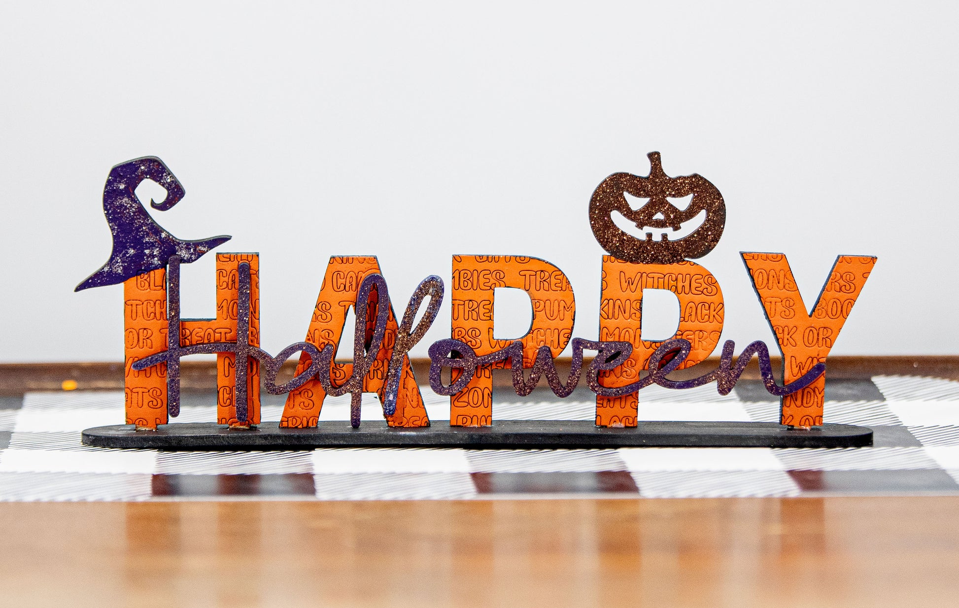 Happy Halloween wooden shelf sitter sign in festive spooky colors, laser-cut layered wood, free-standing design for mantels, shelves, or tiered tray fall decor.
