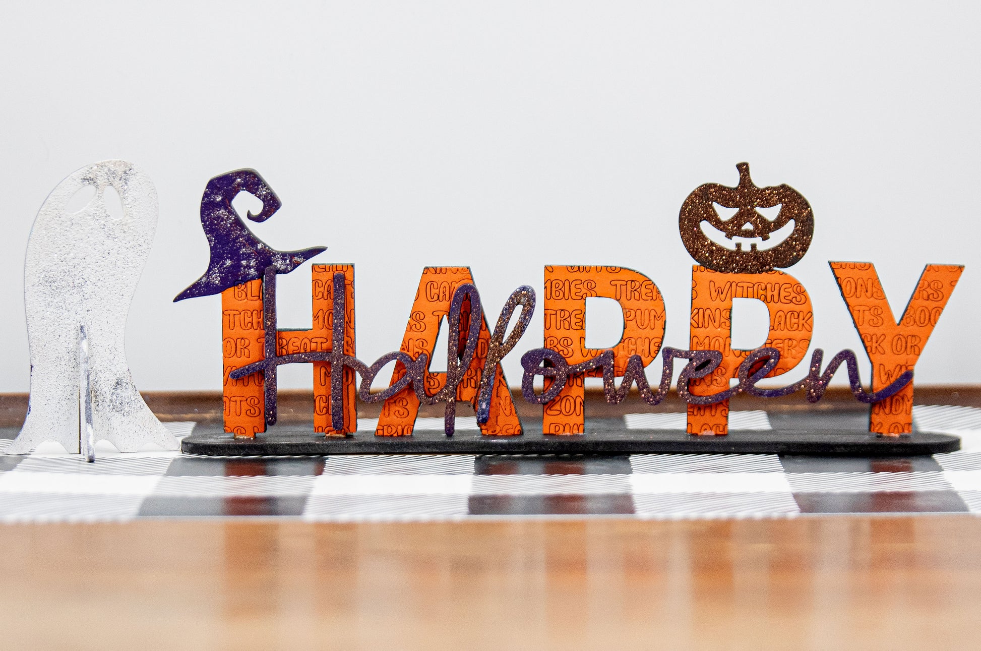 Happy Halloween wooden shelf sitter sign in festive spooky colors, laser-cut layered wood, free-standing design for mantels, shelves, or tiered tray fall decor.
