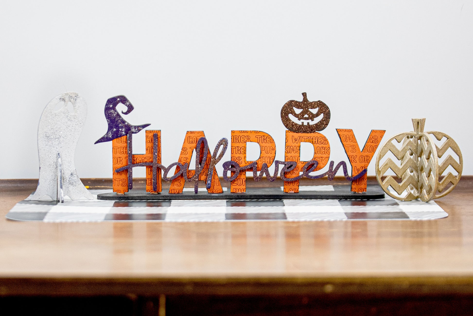 Happy Halloween wooden shelf sitter sign in festive spooky colors, laser-cut layered wood, free-standing design for mantels, shelves, or tiered tray fall decor.
