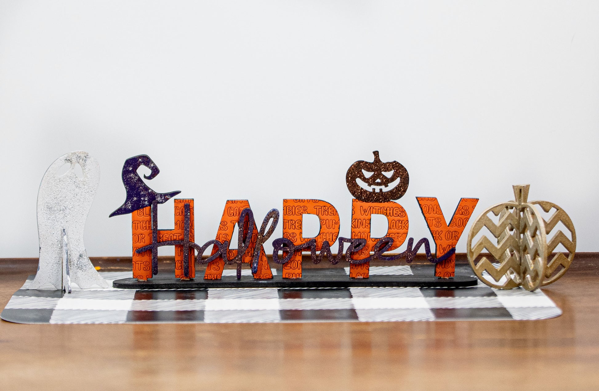 Happy Halloween wooden shelf sitter sign in festive spooky colors, laser-cut layered wood, free-standing design for mantels, shelves, or tiered tray fall decor.
