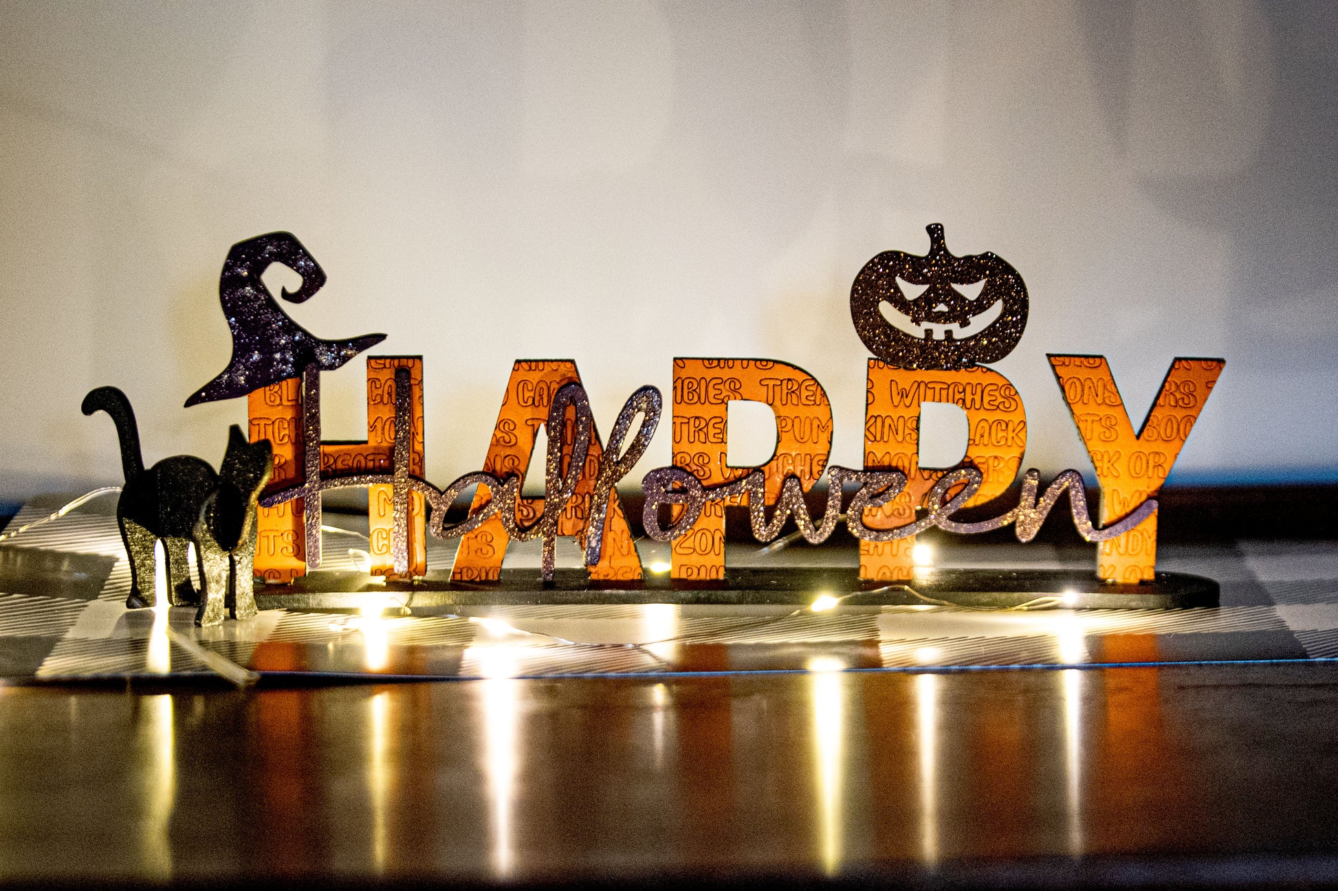 Happy Halloween wooden shelf sitter sign in festive spooky colors, laser-cut layered wood, free-standing design for mantels, shelves, or tiered tray fall decor.
