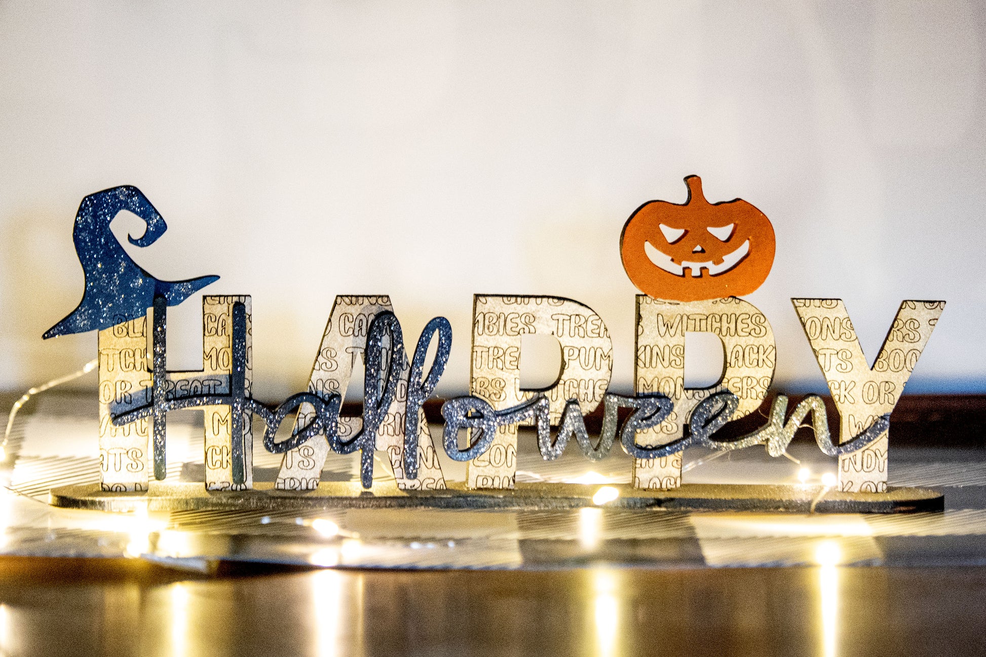 Happy Halloween wooden shelf sitter sign in festive spooky colors, laser-cut layered wood, free-standing design for mantels, shelves, or tiered tray fall decor.
