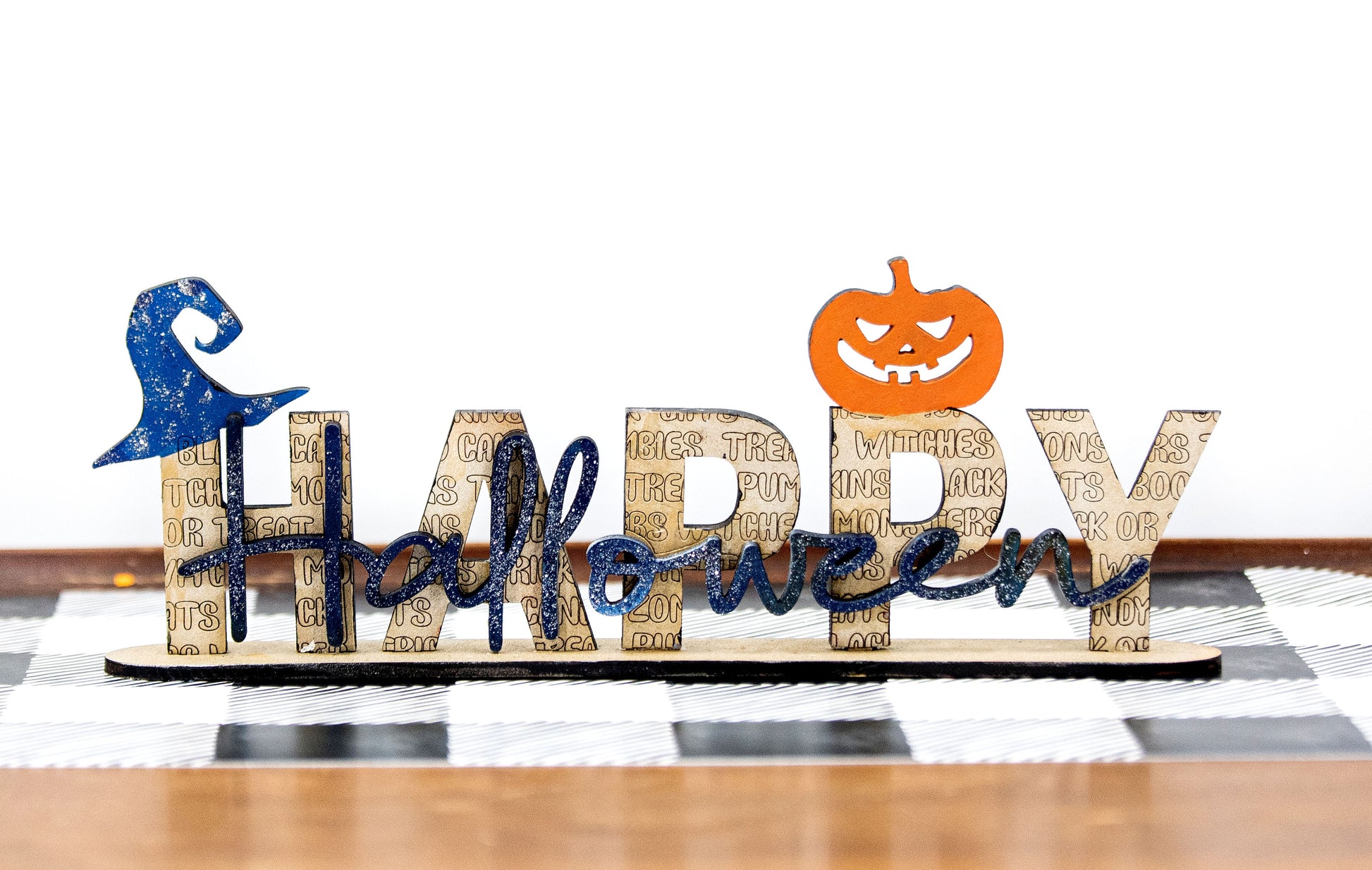 Happy Halloween wooden shelf sitter sign in festive spooky colors, laser-cut layered wood, free-standing design for mantels, shelves, or tiered tray fall decor.
