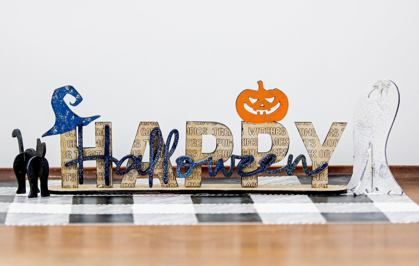 Happy Halloween wooden shelf sitter sign in festive spooky colors, laser-cut layered wood, free-standing design for mantels, shelves, or tiered tray fall decor.
