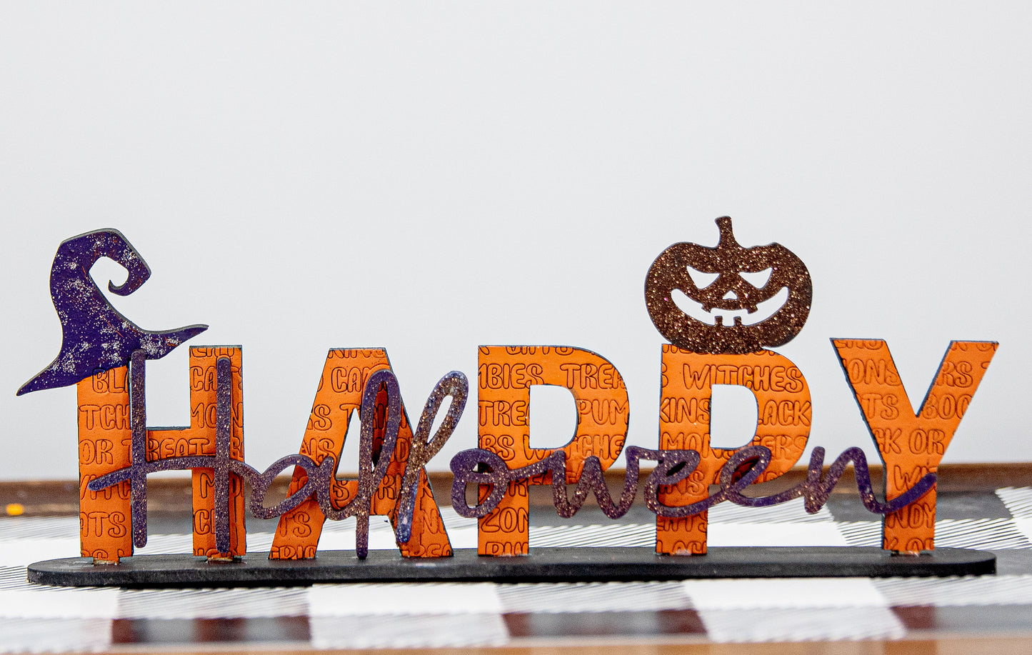 Happy Halloween wooden shelf sitter sign in festive spooky colors, laser-cut layered wood, free-standing design for mantels, shelves, or tiered tray fall decor.
