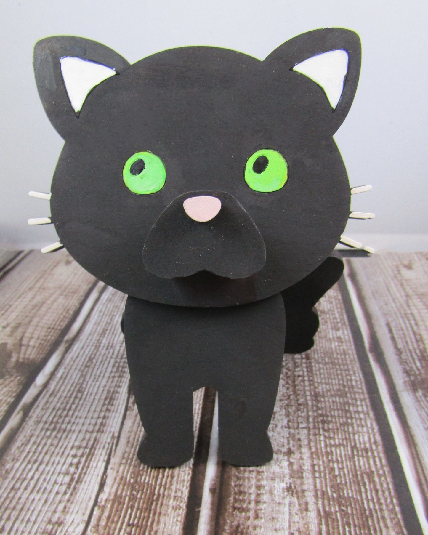 Custom-painted wooden cat glasses holder shaped like a sitting cat with eyeglasses resting on its nose. Available in black, white, orange, gray, tabby, Siamese, tuxedo, or painted from your cat's photo with optional name personalization.