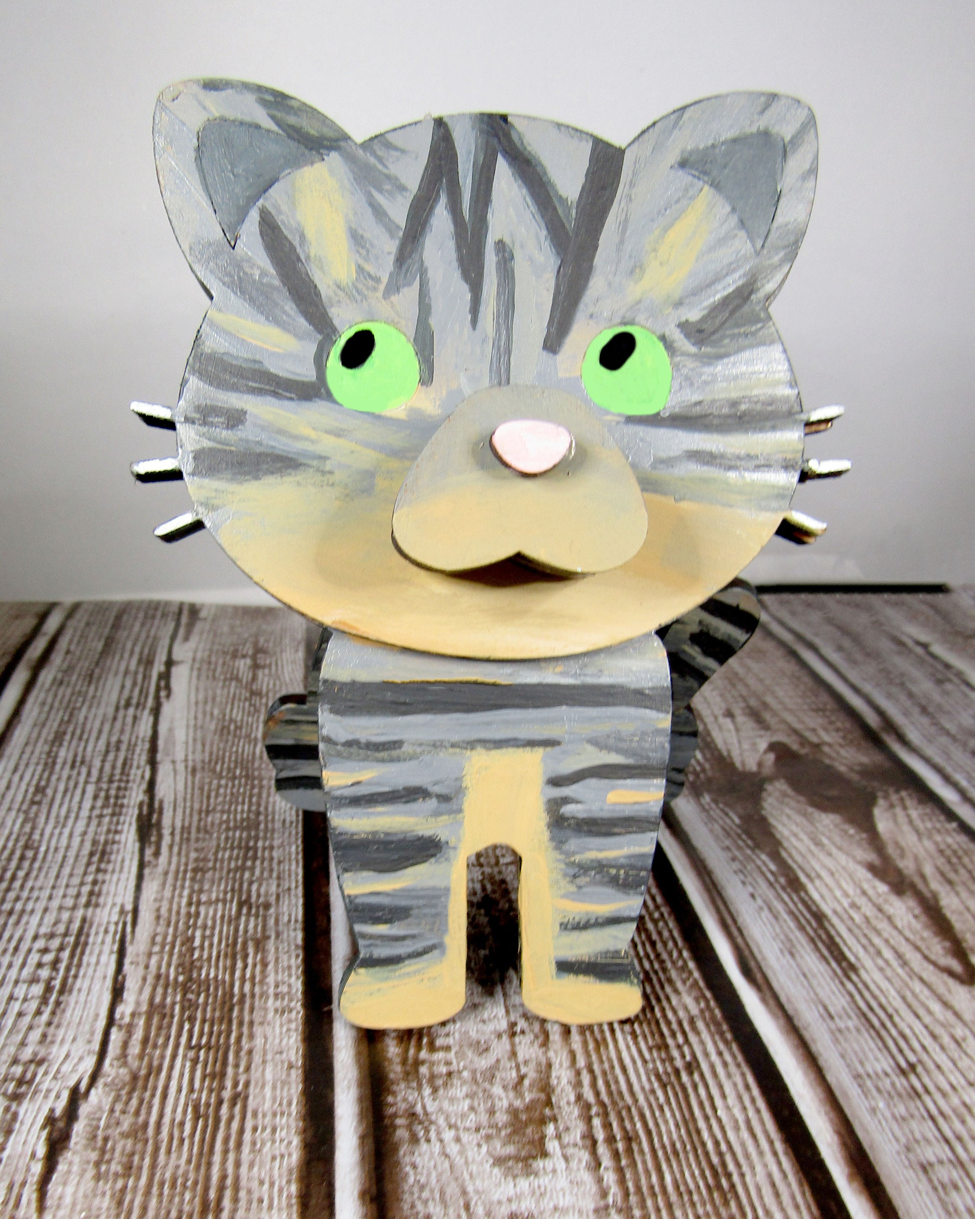 Custom-painted wooden cat glasses holder shaped like a sitting cat with eyeglasses resting on its nose. Available in black, white, orange, gray, tabby, Siamese, tuxedo, or painted from your cat's photo with optional name personalization.