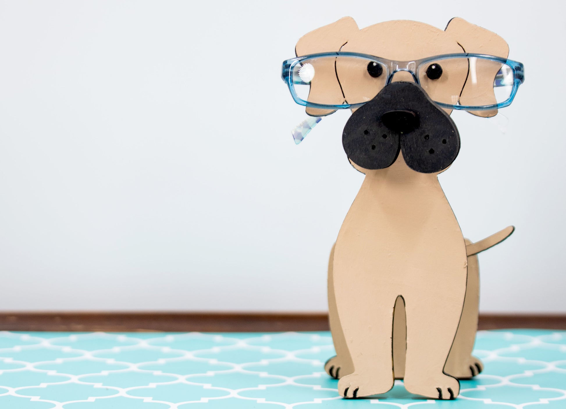 Handmade wooden glasses holder shaped like a Mastiff dog, featuring carved facial details and a sturdy snout that securely holds eyeglasses. Finished in rustic tones with optional personalization, this stand is perfect for Mastiff lovers and adds charm and function to any desk, nightstand, or shelf.