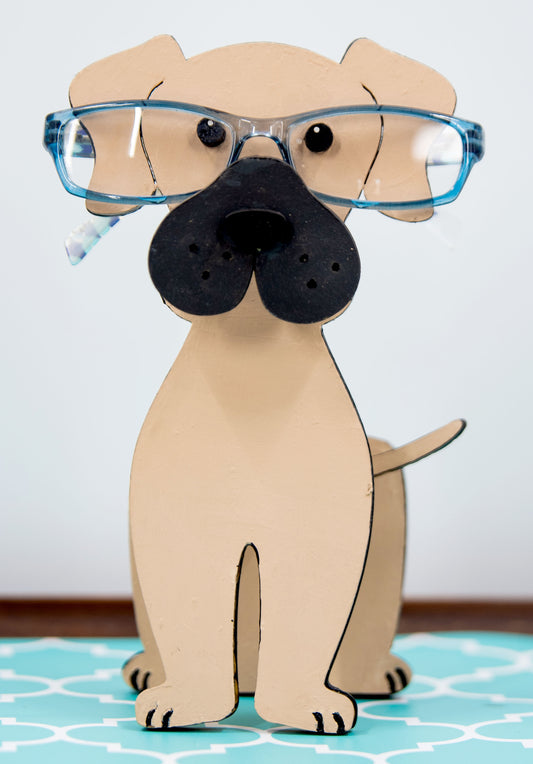 Handmade wooden glasses holder shaped like a Mastiff dog, featuring carved facial details and a sturdy snout that securely holds eyeglasses. Finished in rustic tones with optional personalization, this stand is perfect for Mastiff lovers and adds charm and function to any desk, nightstand, or shelf.