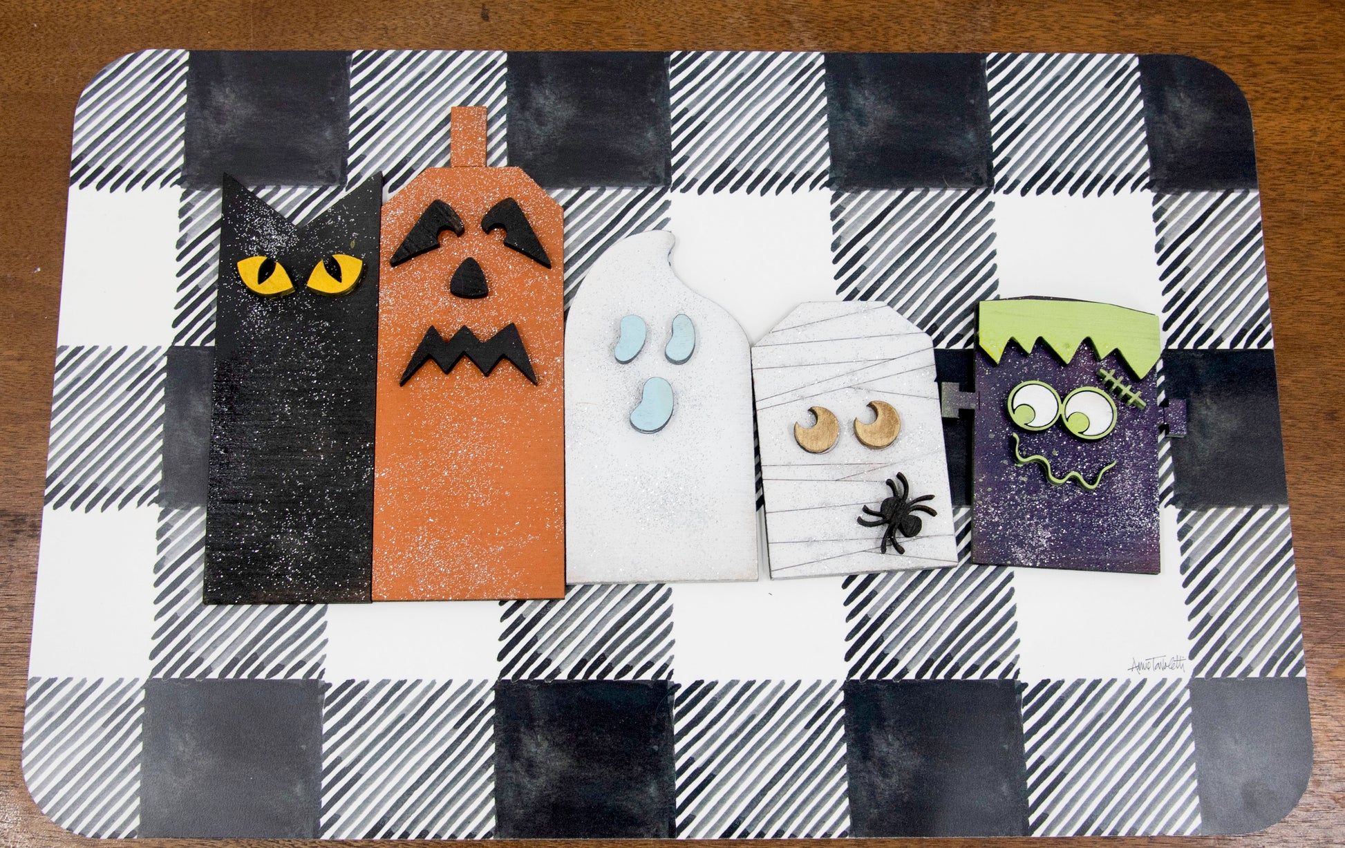 Layered wooden Halloween character shelf sitter set featuring Frankenstein, ghost, black cat, pumpkin, and tombstone. Includes interchangeable face designs, personalized sign text, and multiple size options for Halloween home decor.