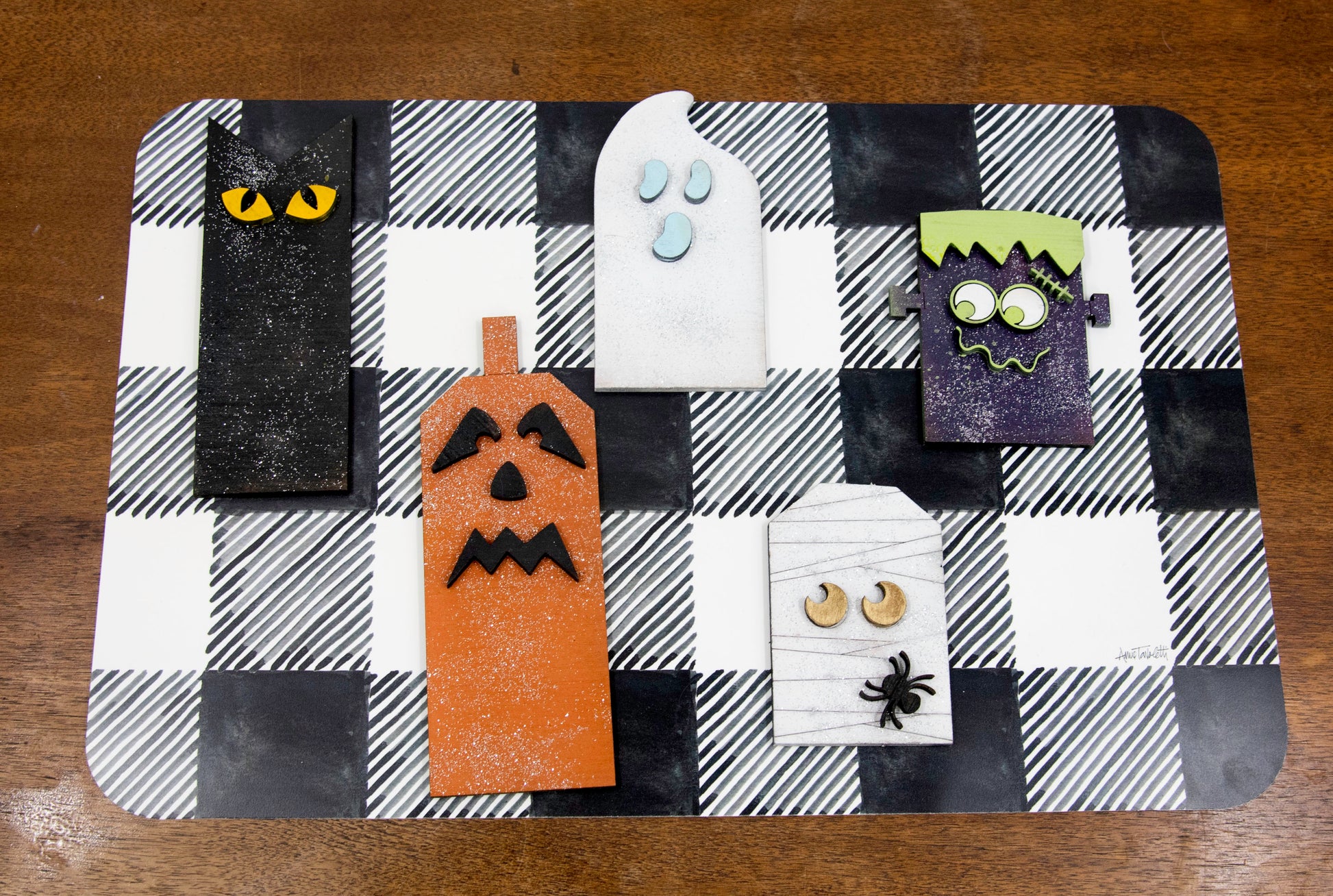 Layered wooden Halloween character shelf sitter set featuring Frankenstein, ghost, black cat, pumpkin, and tombstone. Includes interchangeable face designs, personalized sign text, and multiple size options for Halloween home decor.
