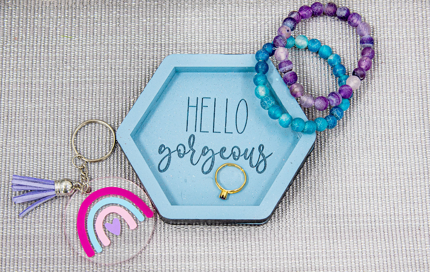 Set of small 3.75-inch round wooden trinket dishes available in various bright colors, each engraved with playful or inspiring sayings like 'Choose Happy,' 'Shit I Can’t Lose,' and 'Collect Moments Not Things.' These colorful dishes work perfectly as jewelry holders, desk catch-alls, or thoughtful gifts