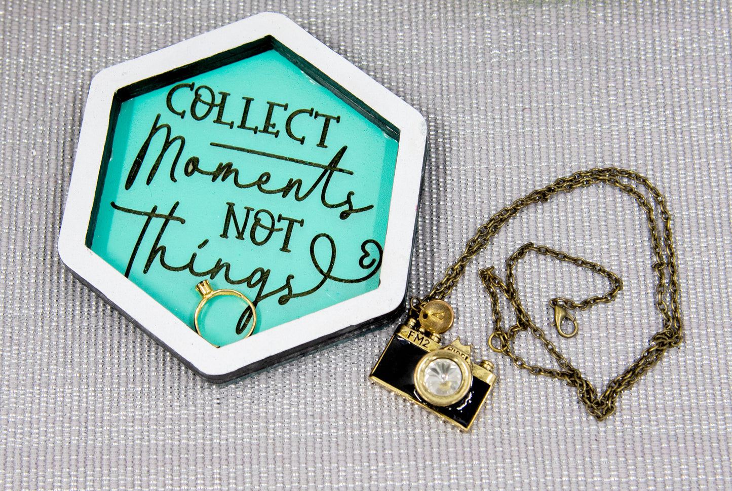 Set of small 3.75-inch round wooden trinket dishes available in various bright colors, each engraved with playful or inspiring sayings like 'Choose Happy,' 'Shit I Can’t Lose,' and 'Collect Moments Not Things.' These colorful dishes work perfectly as jewelry holders, desk catch-alls, or thoughtful gifts