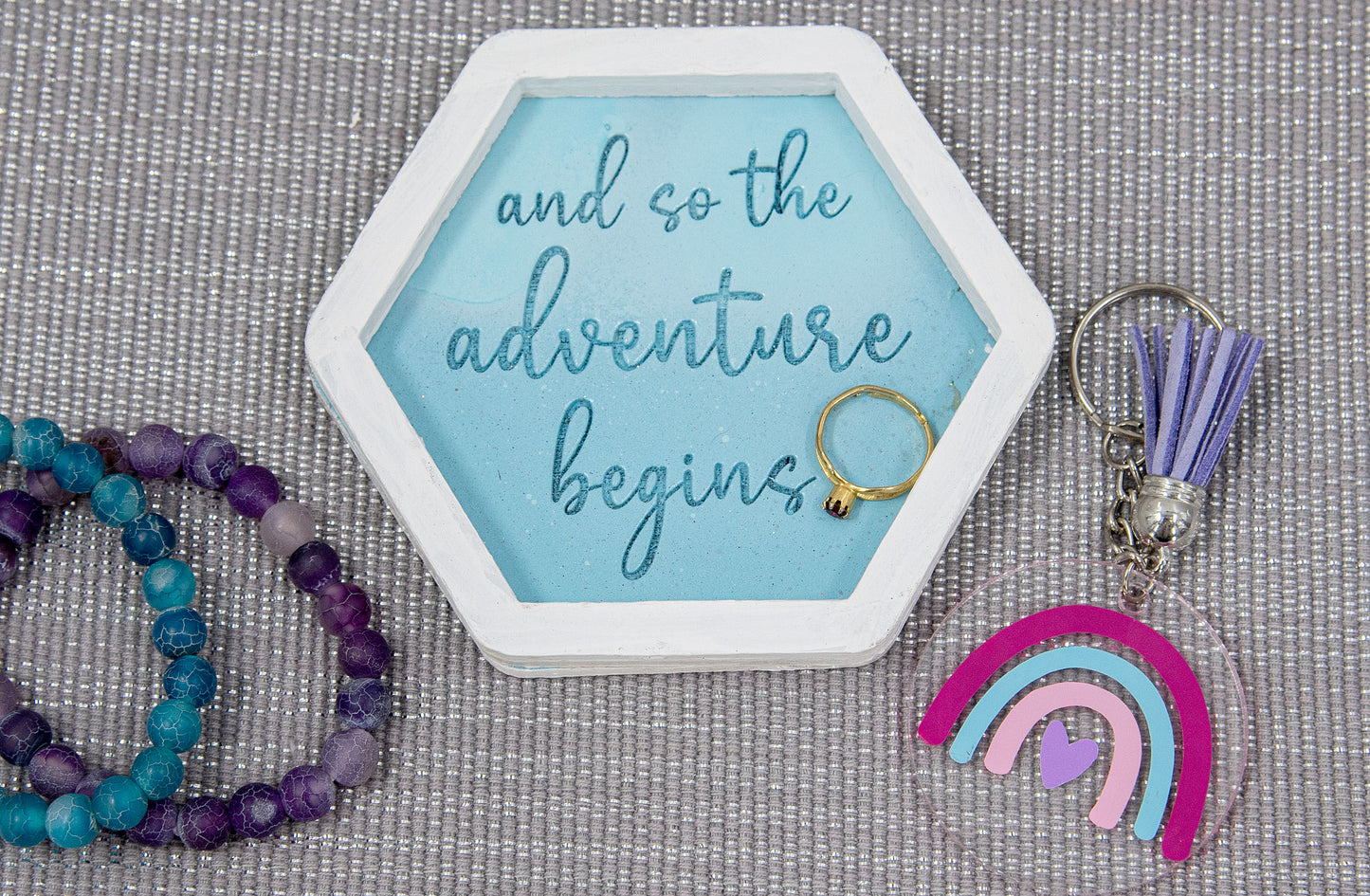 Set of small 3.75-inch round wooden trinket dishes available in various bright colors, each engraved with playful or inspiring sayings like 'Choose Happy,' 'Shit I Can’t Lose,' and 'Collect Moments Not Things.' These colorful dishes work perfectly as jewelry holders, desk catch-alls, or thoughtful gifts