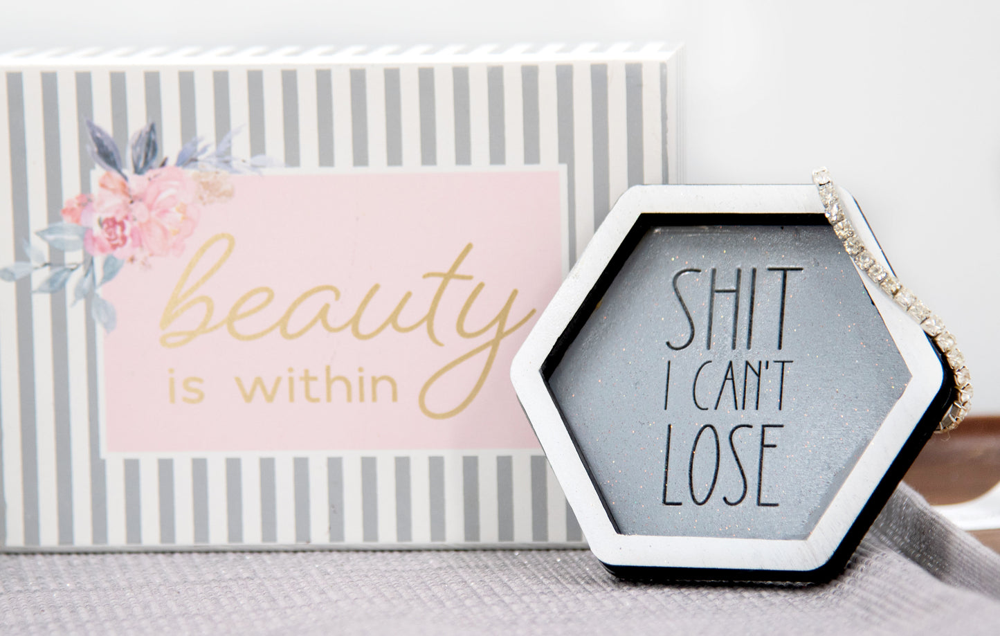 Set of small 3.75-inch round wooden trinket dishes available in various bright colors, each engraved with playful or inspiring sayings like 'Choose Happy,' 'Shit I Can’t Lose,' and 'Collect Moments Not Things.' These colorful dishes work perfectly as jewelry holders, desk catch-alls, or thoughtful gifts