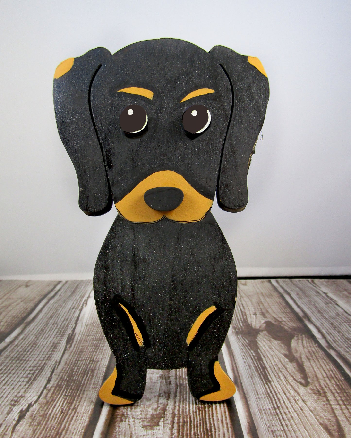 Large stained dachshund glasses holder made from solid wood, shown in red/brown finish, designed to keep eyeglasses secure while adding charm to your decor. Handmade eyeglass stand shaped like a dachshund with adorable detailing, perfect for bedside tables, desks, or as a thoughtful gift for dog lovers. Available in red/brown, black, or custom stain colors to match your style.