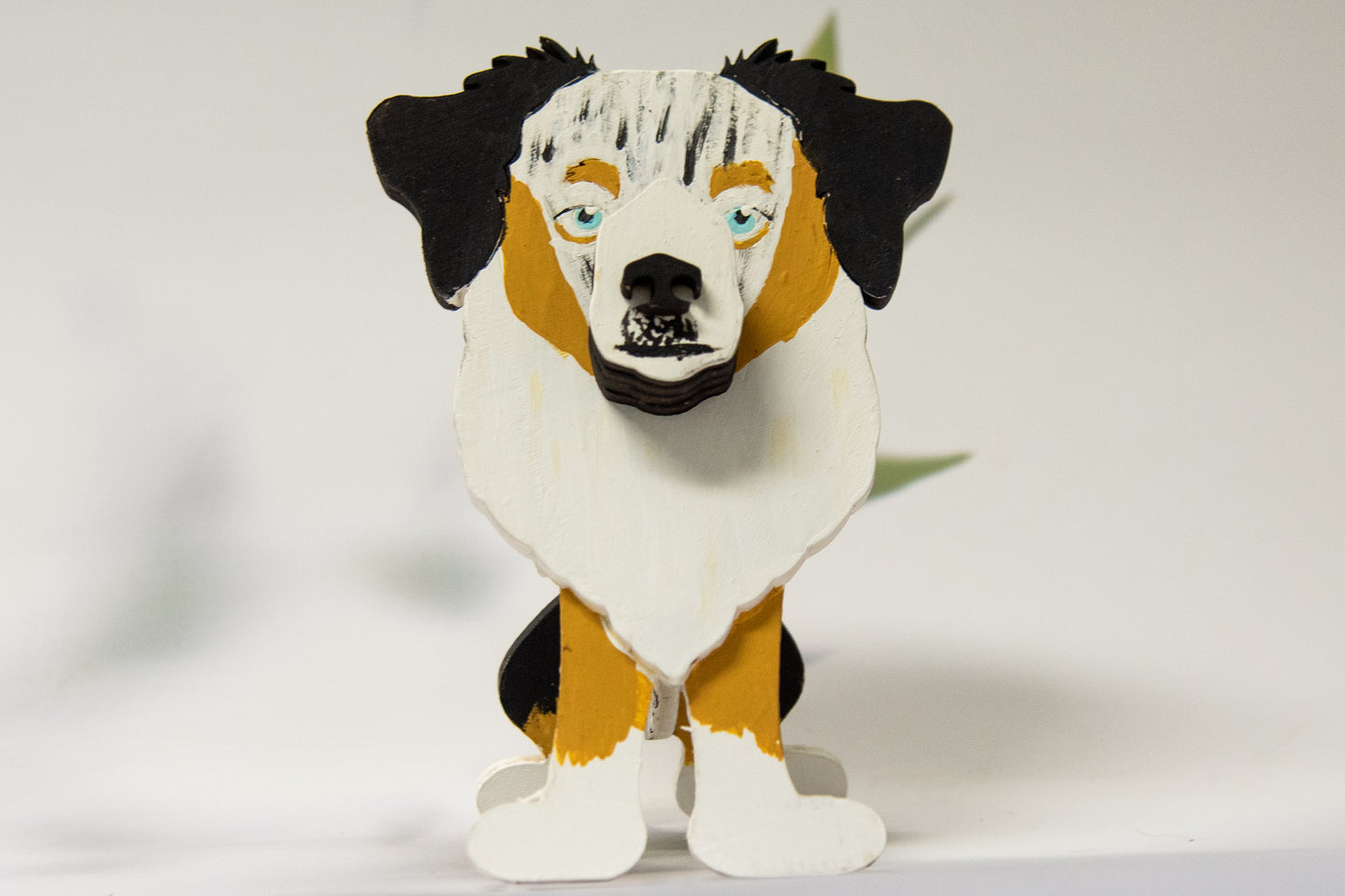 Hand-painted Australian Shepherd eyeglass holder in a sitting dog shape, available in Blue Merle, Red Merle, Black Tri, or custom colors with realistic details, designed to hold glasses on the snout. Cute and functional dog lover gift, hand-crafted and great for desks or nightstands.