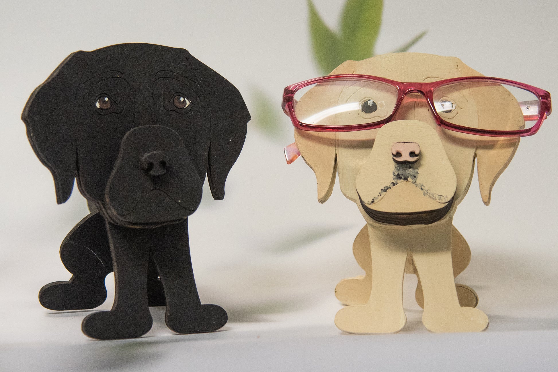 Custom handmade glasses holder shaped like a black and yellow Labrador Retriever, designed to hold eyeglasses or sunglasses. Features include a wooden build, optional DIY kit for paint-your-own fun, and an engraved nameplate for personalization. Shown assembled and with DIY parts, this functional and decorative dog-shaped
