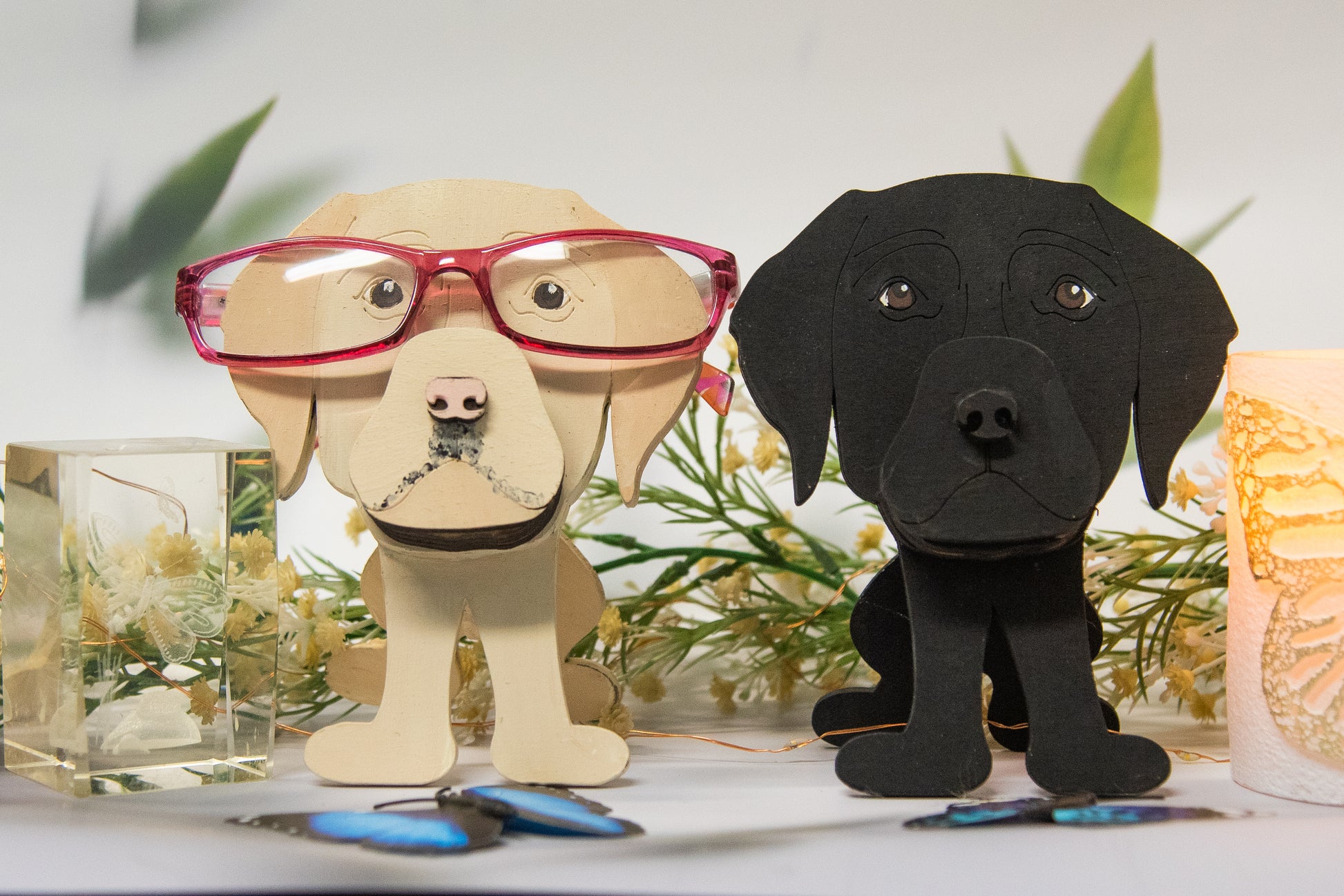 Custom handmade glasses holder shaped like a black and yellow Labrador Retriever, designed to hold eyeglasses or sunglasses. Features include a wooden build, optional DIY kit for paint-your-own fun, and an engraved nameplate for personalization. Shown assembled and with DIY parts, this functional and decorative dog-shaped