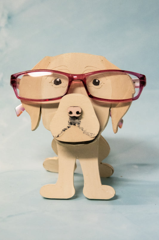 Custom handmade glasses holder shaped like a black and yellow Labrador Retriever, designed to hold eyeglasses or sunglasses. Features include a wooden build, optional DIY kit for paint-your-own fun, and an engraved nameplate for personalization. Shown assembled and with DIY parts, this functional and decorative dog-shaped