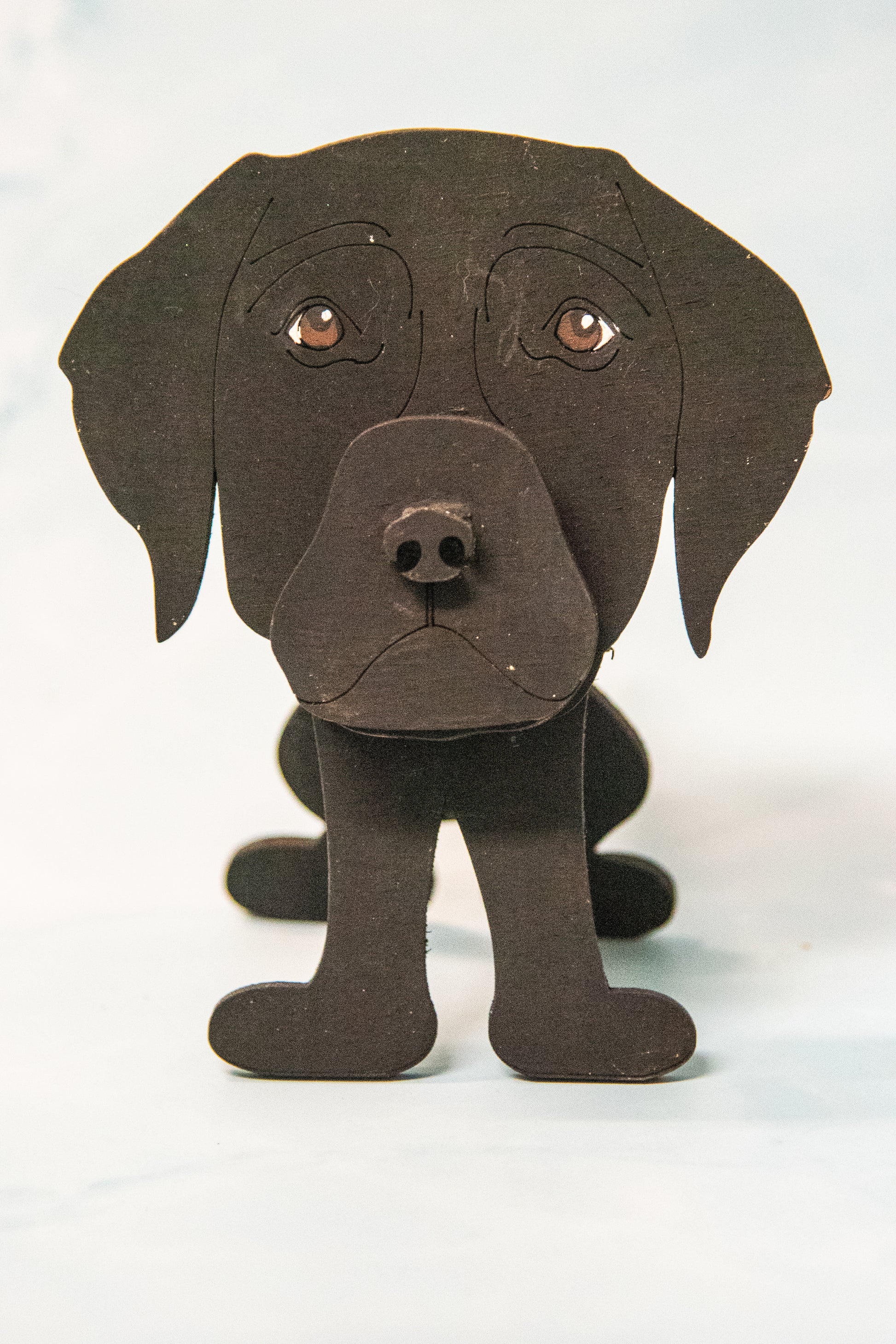 Custom handmade glasses holder shaped like a black and yellow Labrador Retriever, designed to hold eyeglasses or sunglasses. Features include a wooden build, optional DIY kit for paint-your-own fun, and an engraved nameplate for personalization. Shown assembled and with DIY parts, this functional and decorative dog-shaped